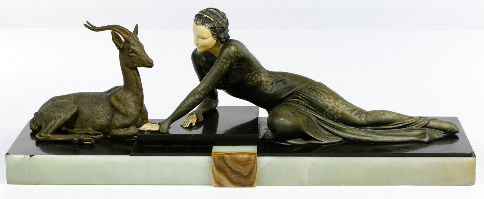 E. Menneville (French, 20th Century) Art Deco Spelter: E. Menneville (French, 20th Century) Art Deco Spelter and Ivorine Statue Undated, signed on front right corner; depicting a reclining woman and a gazelle, having a marble base; sales receipt from Spen