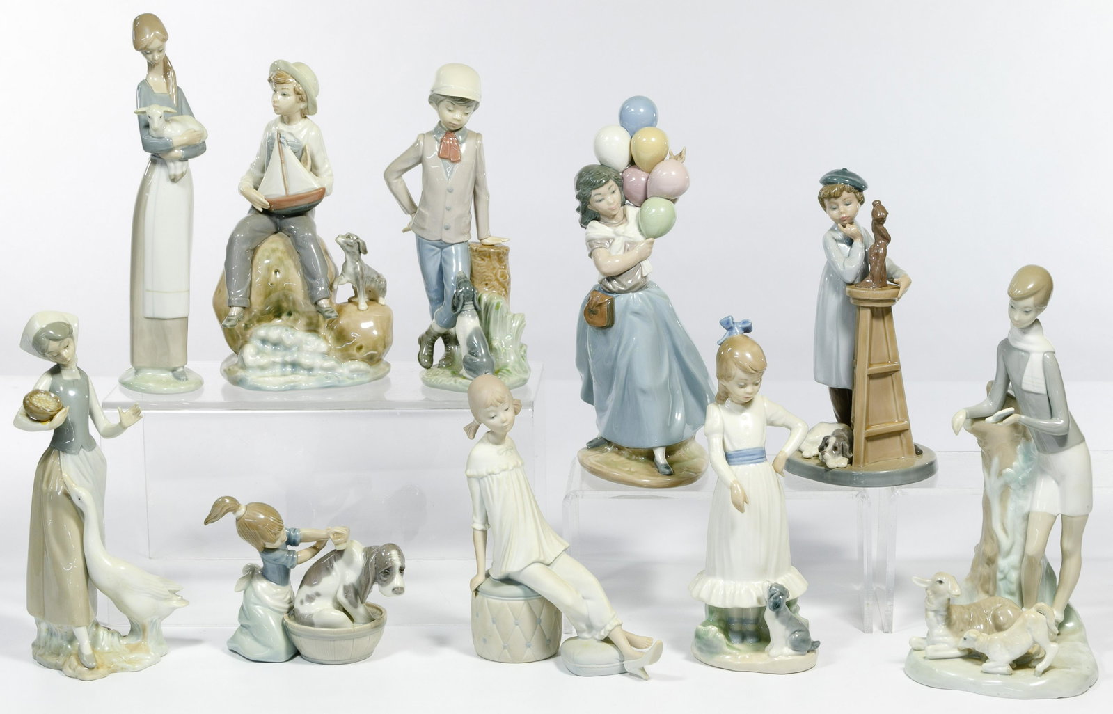 Lladro Figurine Assortment: Lladro Figurine Assortment Twenty-one items including Lladro #4505 'Girl with Lamb' retired 2001, #5455 'Bashful Bather' active, #5358 'Little Sculptor' retired 1989, #1052 'Girl Feeding Goose' retire