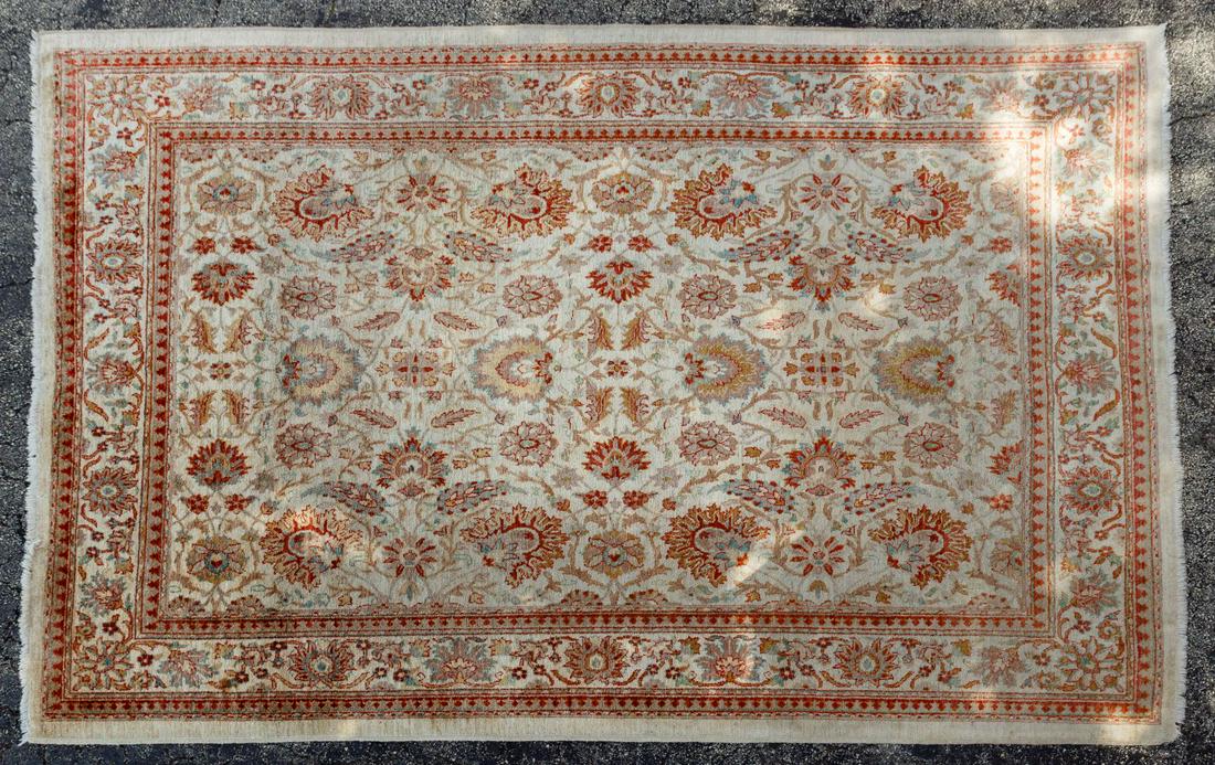 Wool Area Rug: Wool Area Rug Floral motif with cream background, hues of blue, rust and green Condition: Good, moderate wear, fringe cut, stain in semi-circle on one side Length: 131 inches, Width: 94 1/2 inches Cat