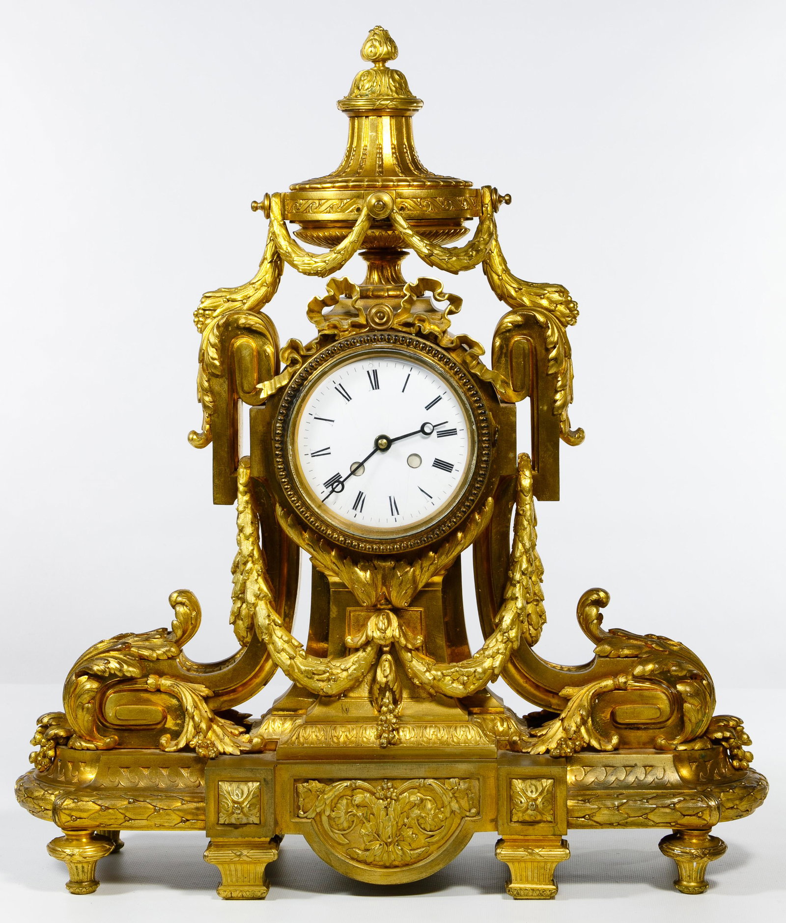 Baroque Style Ormolu Mantel Clock: Baroque Style Ormolu Mantel Clock Victory cup, garland and bows motif; together with movement marked 'N.C. 1011' and pendulum Condition: Good, moderate wear, some finish worn, right front leg loose, f