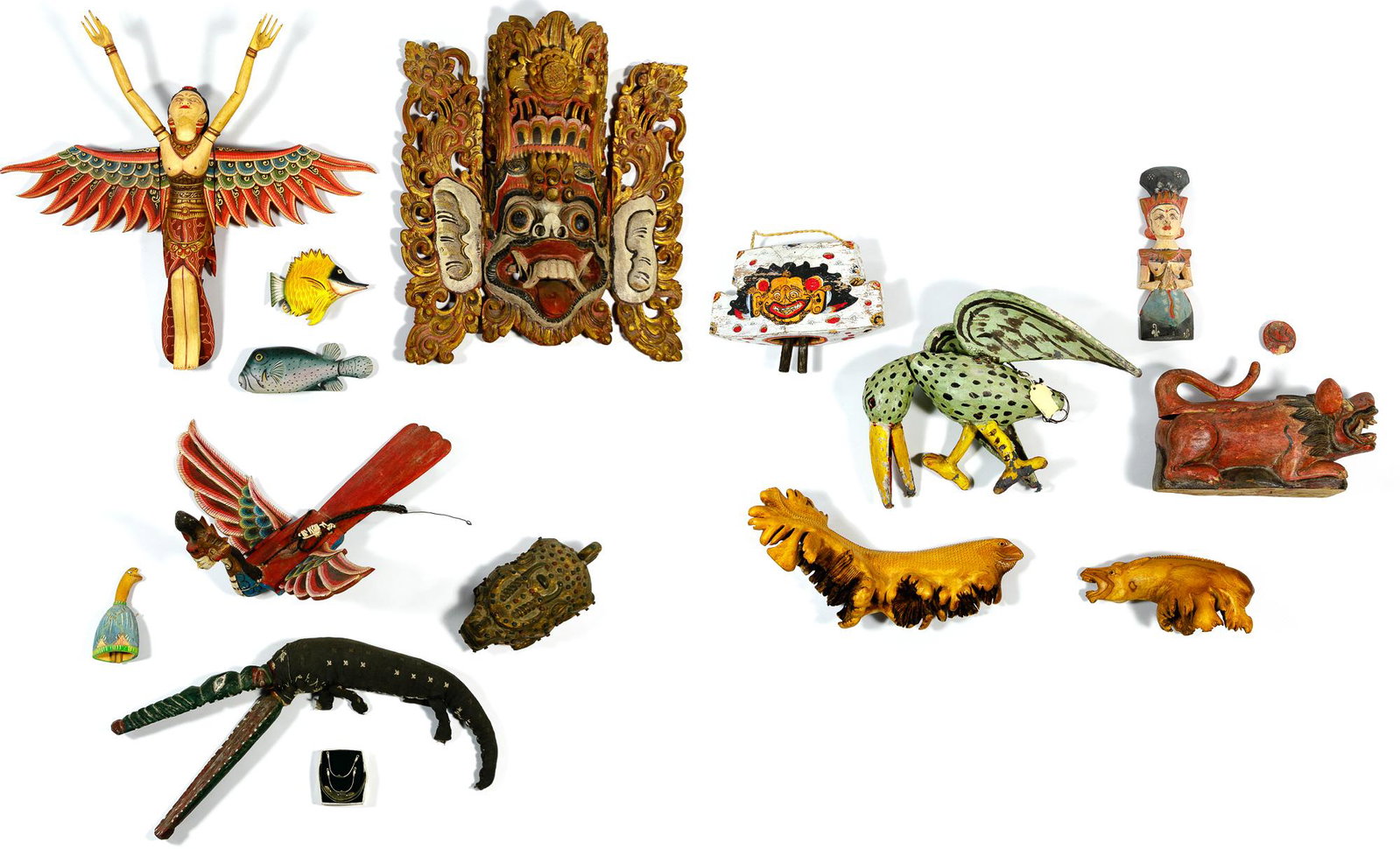 Indonesian Carved Figural Assortment: Indonesian Carved Figural Assortment Fifteen items including carved wood painted and unpainted items, depicting female, mythical and animal figures, bells and a mask; together with four metal items Co