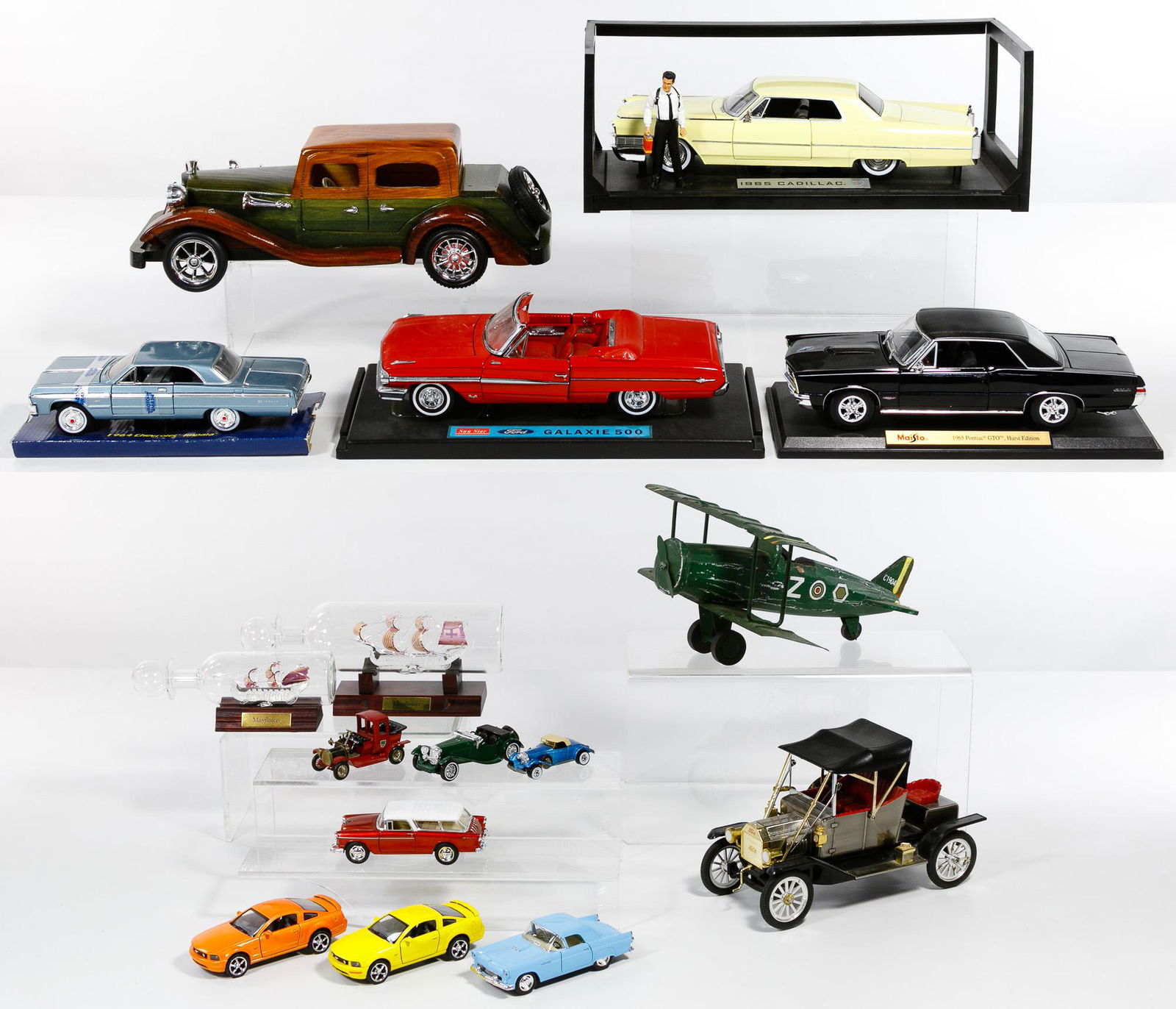 Model Car Assortment: Model Car Assortment Sixteen items including display models of a 1965 Pontiac GTO, a Galaxie 500 and a 1965 Cadillac all on stands; a 1964 Chevrolet Impala and a wood 1940's style sedan; four models b