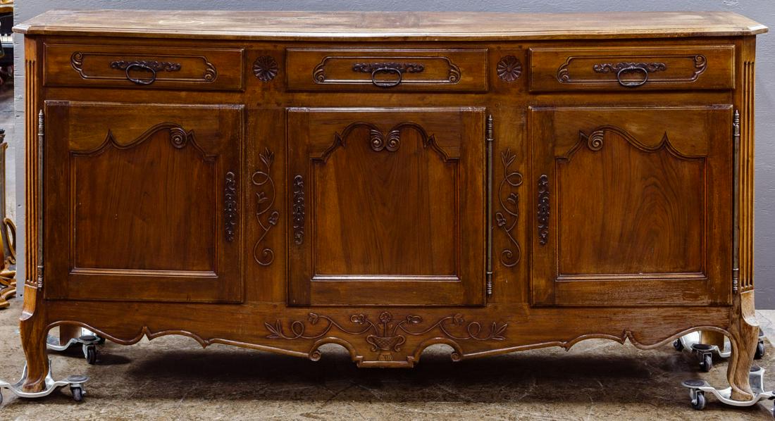 Provincial Carved Panel Cabinet: Provincial Carved Panel Cabinet 19th century pegged frame cabinet having fluted chamfered legs, shaped and carved skirt, three Baroque style framed panel doors hung on full-length brass French hinges,