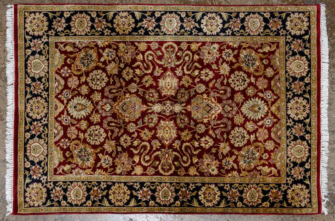 Chinese Area Rug: Chinese Area Rug Abstract floral motif with black border and red center, having hues of white and gold Condition: Good, moderate wear, some fading, some missing fringe Length: 67 inches, Width: 48 inc