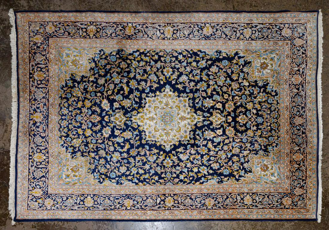 Persian Wool Area Rug: Persian Wool Area Rug Cream and blue border, with medallion middle in a floral motif Condition: Good, moderate wear, 24-inch repair near label, some fringe cut in areas, some fading Length: 136 inches