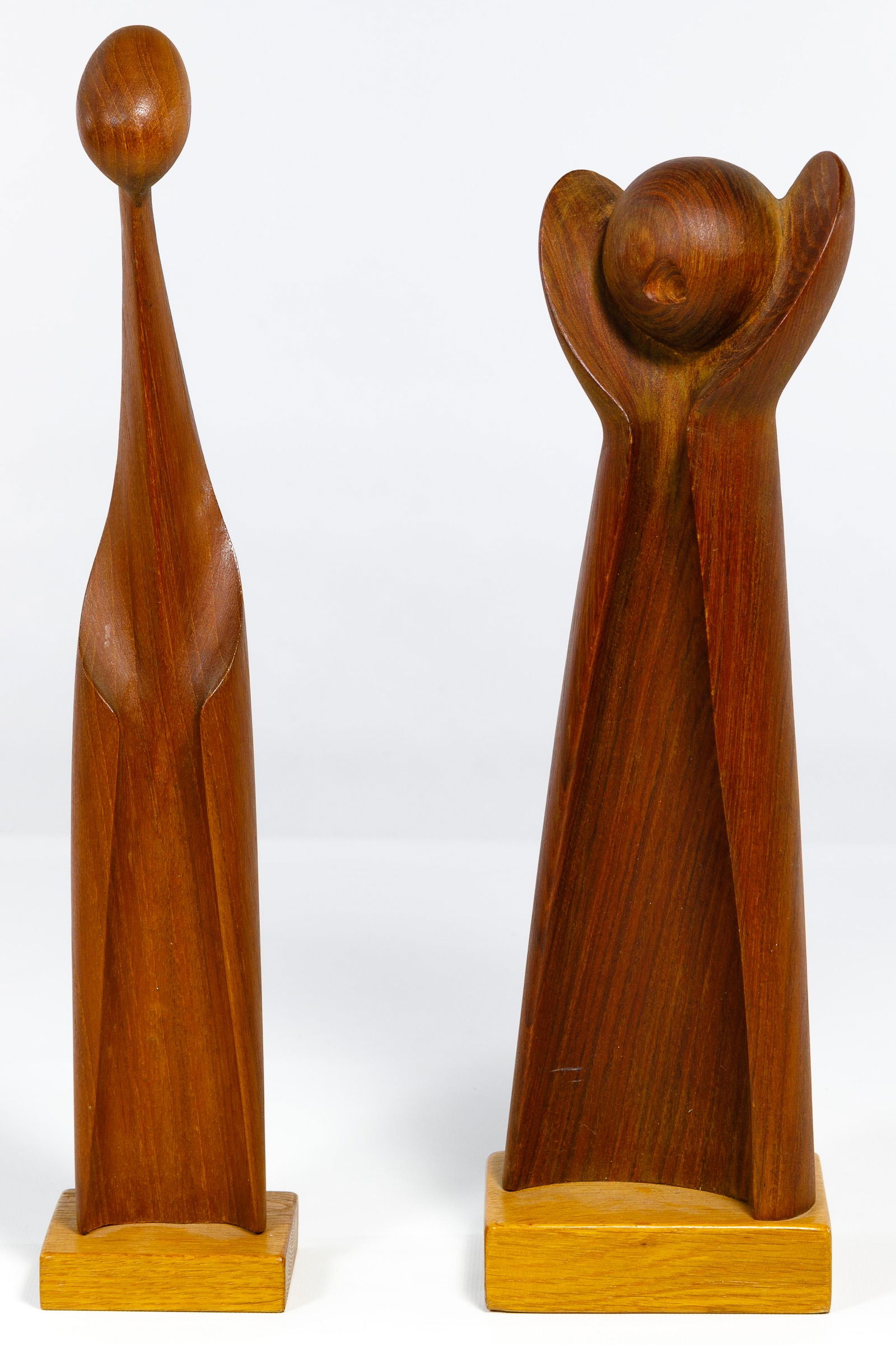 Raymor Wood Statues: Raymor Wood Statues Two carved figural statues mounted on contrasting wood plinths; one having the Raymor label on underside, the other signed 'Simon' on the back and stamped 'Denmark' on underside Co