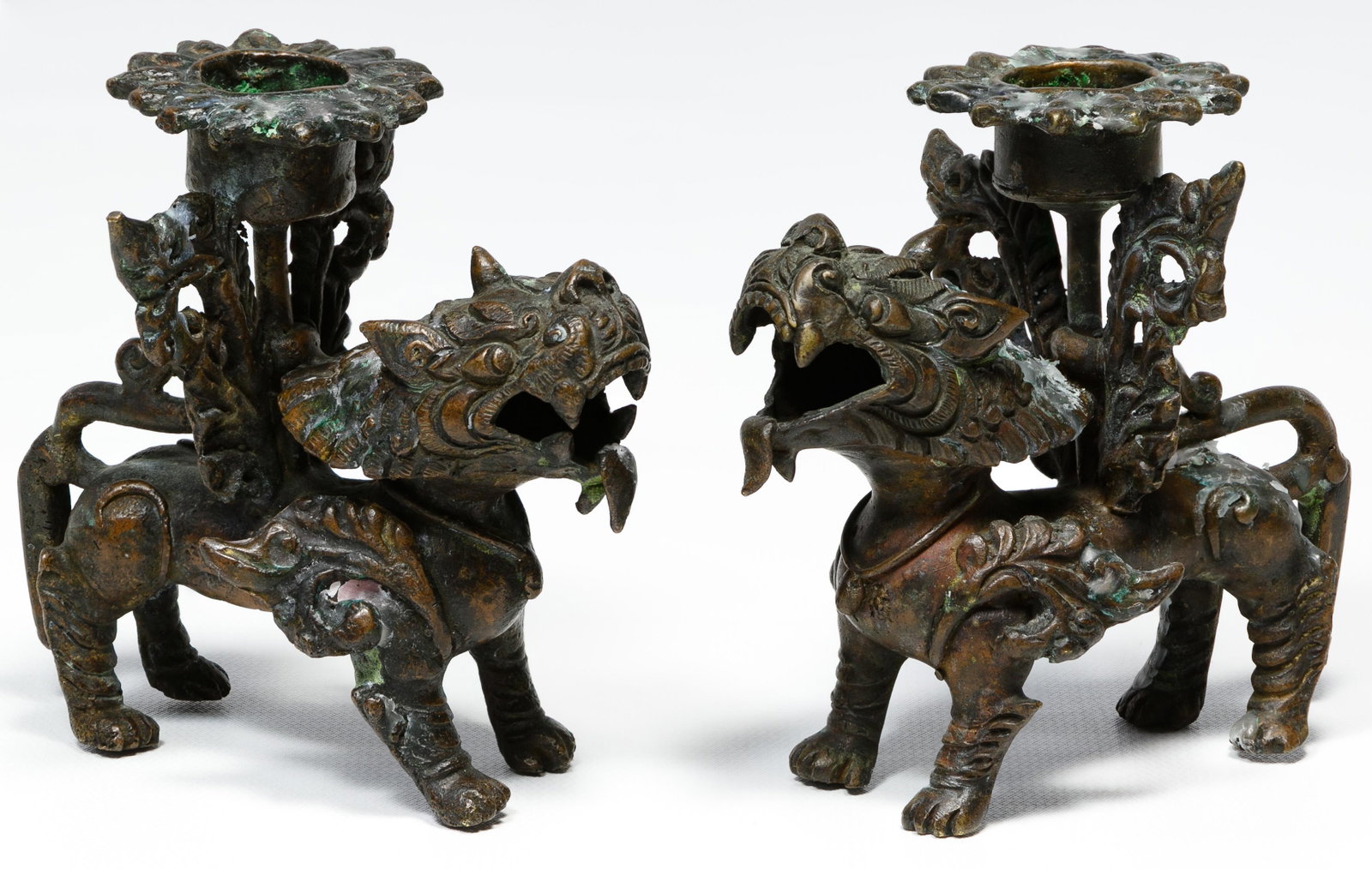 Asian Style Metal Foo Dog Candle Holders: Asian Style Metal Foo Dog Candle Holders Two candle holders depicting winged foo dogs having open mouths Condition: Good, overall light wear consistent with age and normal use; some tarnish and wax re