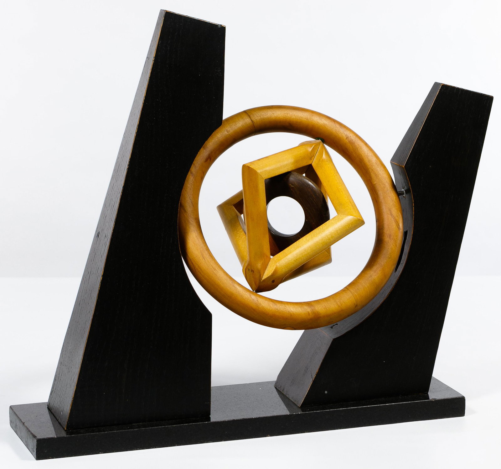 Unknown Artist (American, 20th Century) Abstract: Unknown Artist (American, 20th Century) Abstract Kinetic Sculpture c.1980, unsigned, composed of three concentric wood carvings that spin on three axes between asymmetric painted wood pillars atop a g
