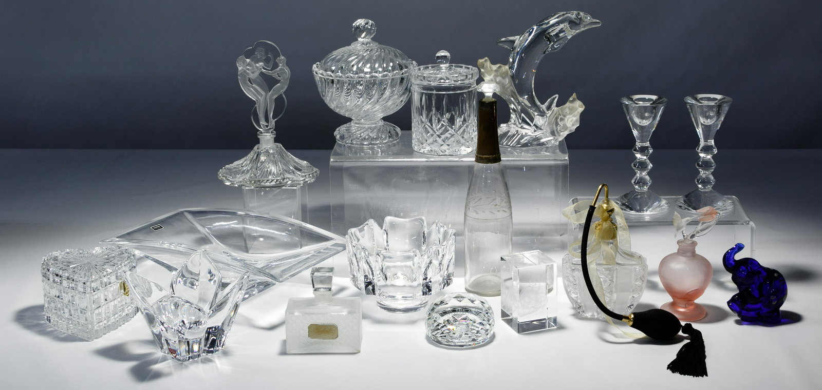 Crystal Assortment: Crystal Assortment Seventeen items including a pair Baccarat candle holders and pedestal bowl having lid, two Orefors bowls, Lenox dolphin, five perfume bottles, two paperweights, jam jar, heart box, 