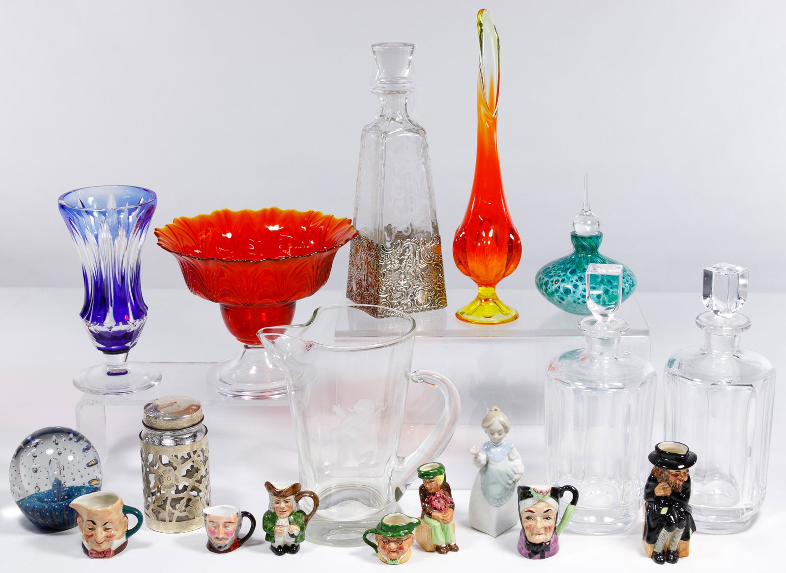 Porcelain, Crystal and Glass Assortment: Porcelain, Crystal and Glass Assortment Eighteen items including Lladro #5939 'Mrs. Claus' Christmas ornament, retired; Artone and Royal Doulton miniature toby mugs, art glass paperweight and vase, de