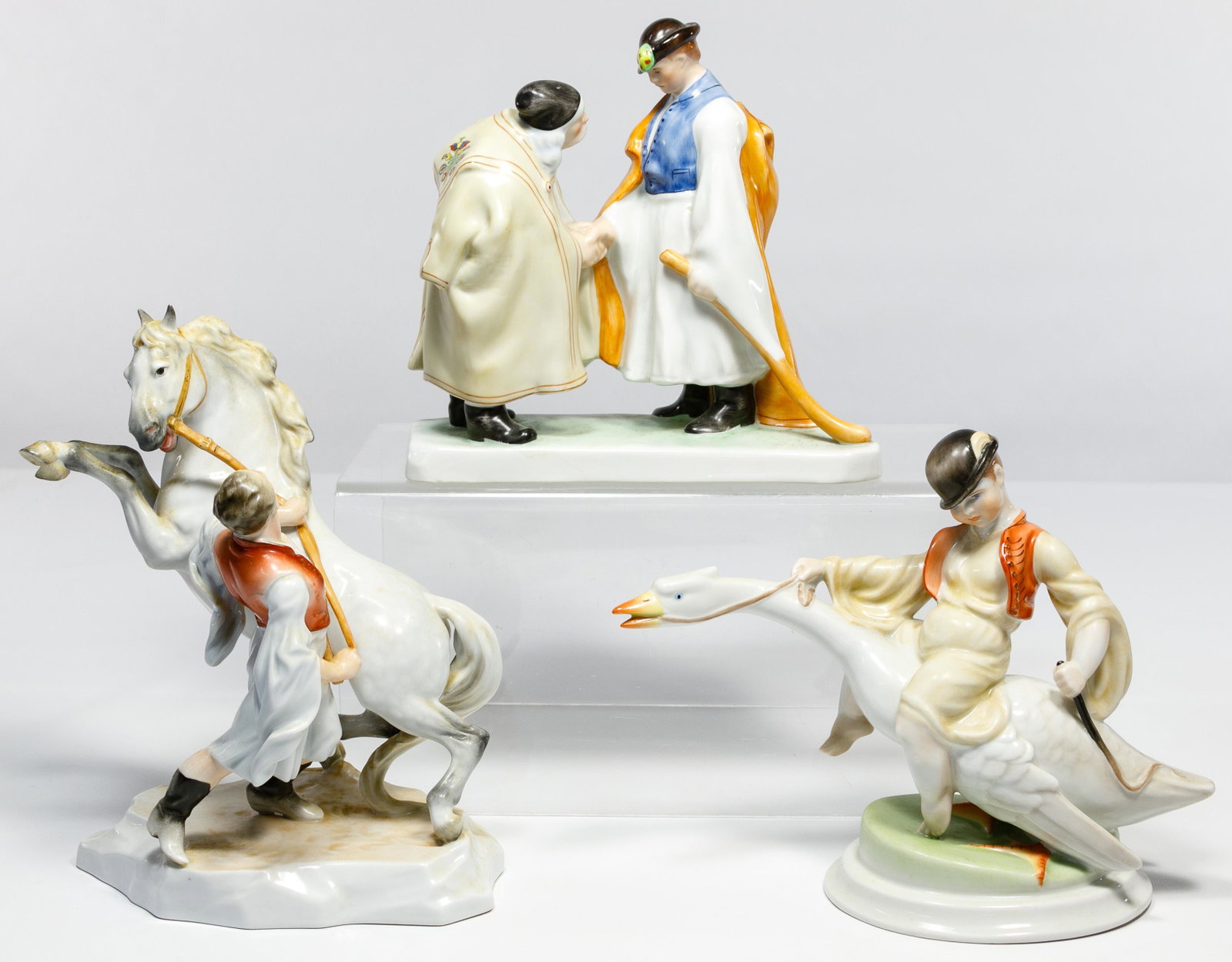 Herend Porcelain Figurine Assortment: Herend Porcelain Figurine Assortment Three items including #5515 a boy riding goose, #5506 two men shaking hands and #5470 a man wrangling a horse; all having maker mark on underside Condition: Very G