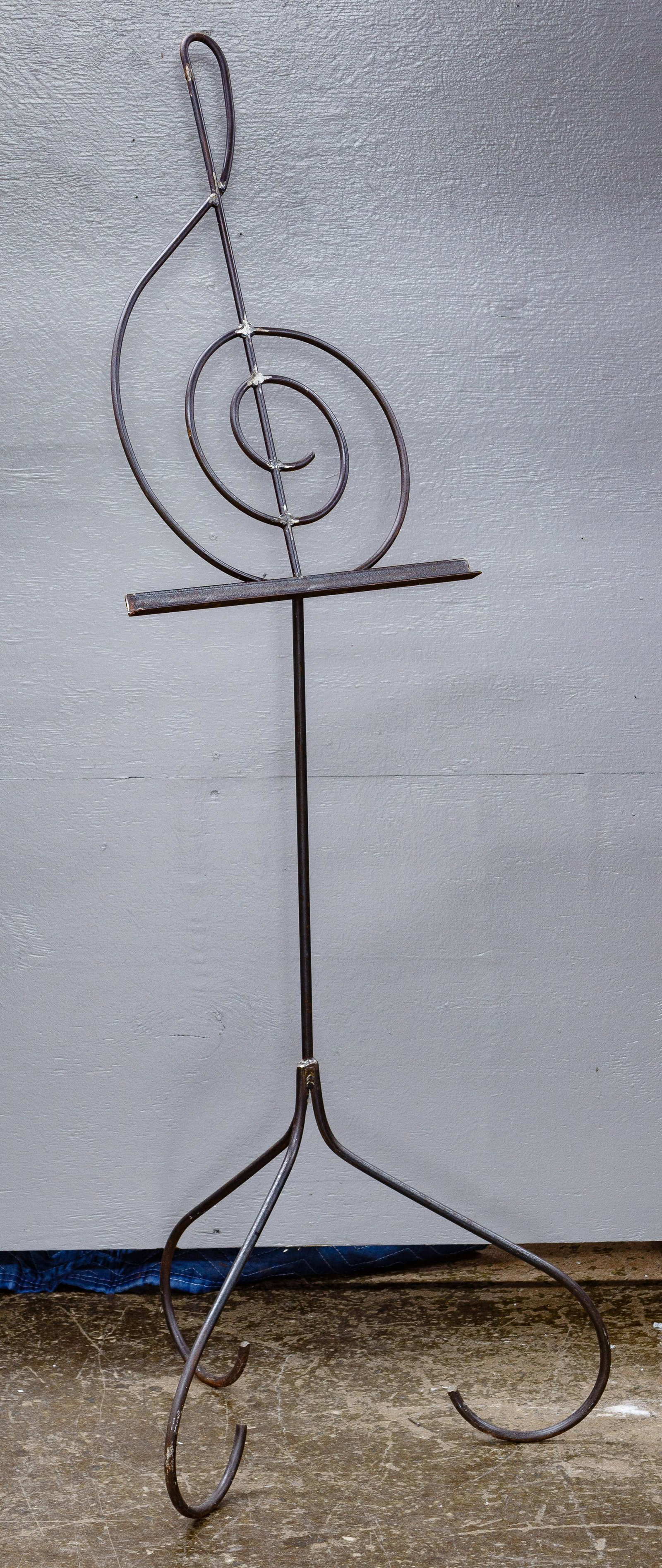 Treble Clef Music Stand: Treble Clef Music Stand Welded metal having curved legs and ledge for sheet music Condition: Very Good, overall light wear consistent with age and normal use Height: 63 inches, Width: 22 inches Catego