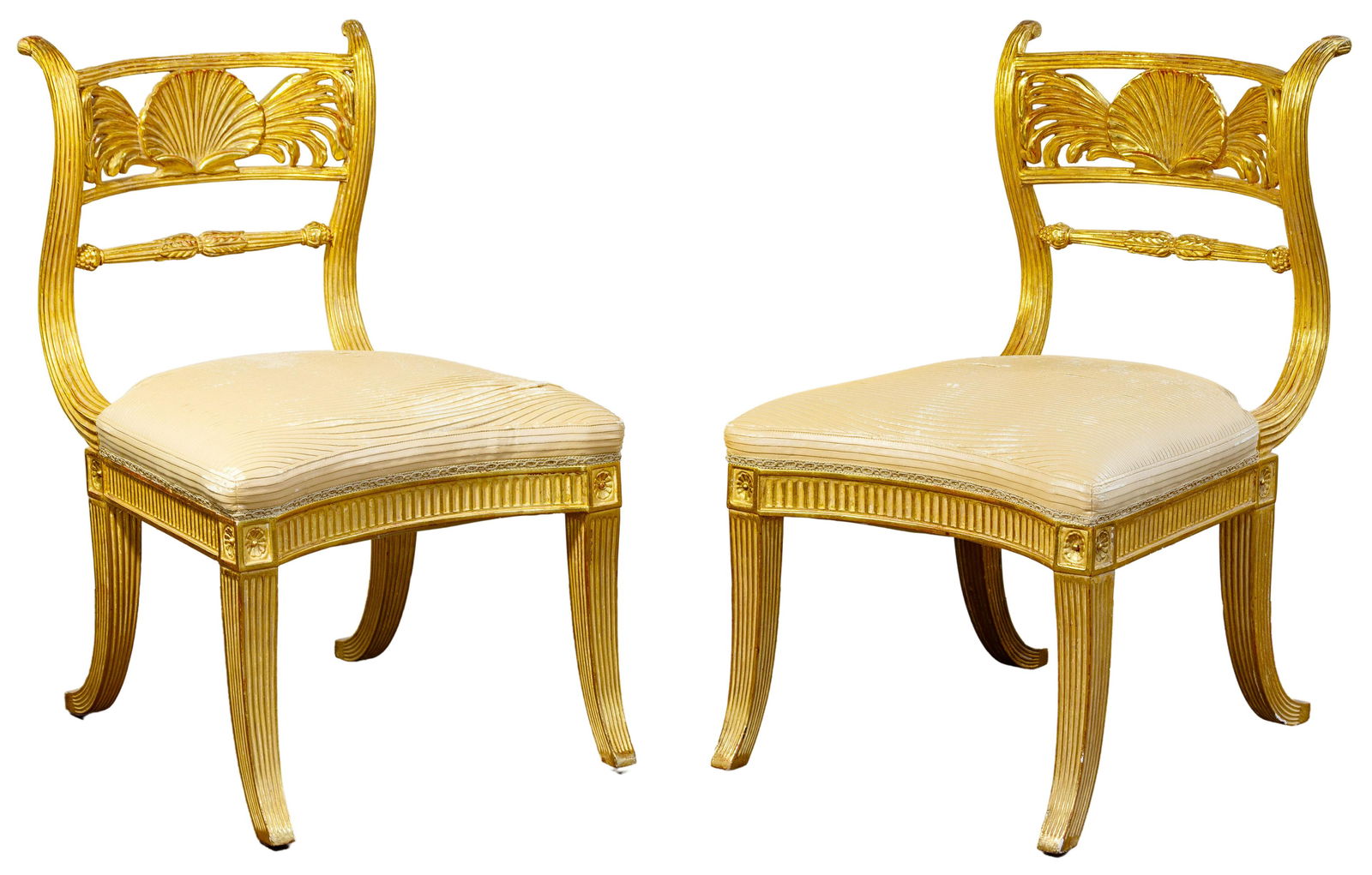 Gold Gilt Carved Arm Chairs: Gold Gilt Carved Arm Chairs Pair having a pleated leather seat, carved shell motif on cresting rail, fluted curved legs, arched apron; property from a Chicago, Illinois collector Condition: Good, over