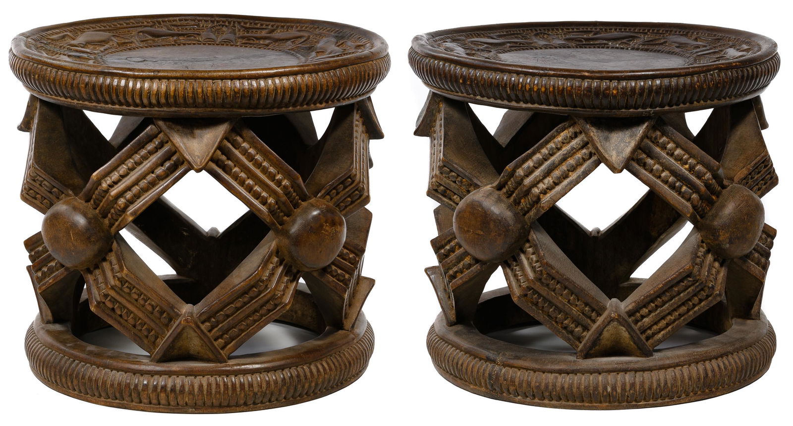 African Bamileke Style Carved Wood Stools: African Bamileke Style Carved Wood Stools 20th century, pair of carved wood stools or drum tables, each having an 'X' shaped 'spider web' pattern on the sides and depicting lizards on the top Conditio