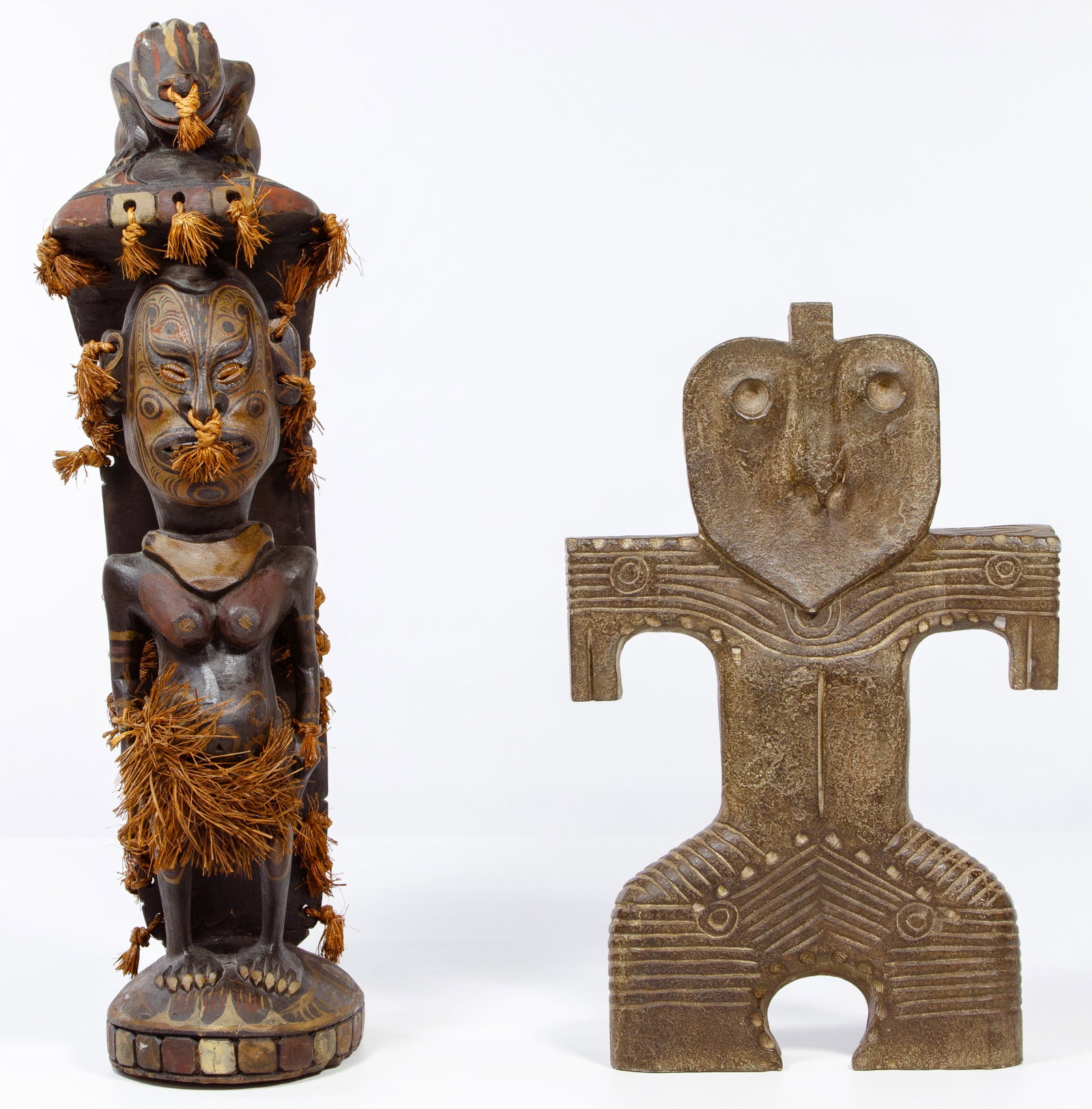 Maori and Japanese Sculptures: Maori and Japanese Sculptures Two items including New Zealand Maori, carved woman having painted art tattoos and a lizard draped over her head; and a Jamon Dogu stone sculpture; property from a Highla