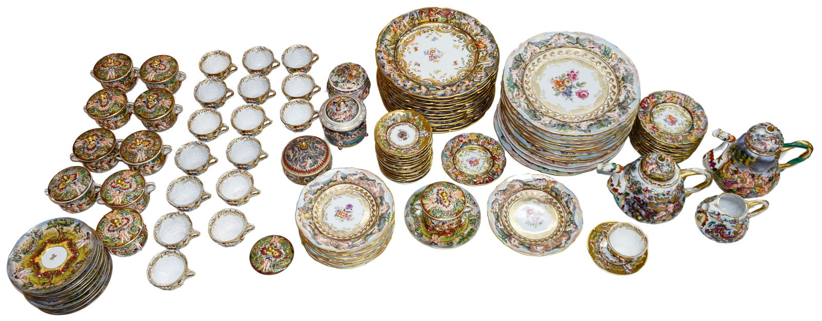 Capo-di-Monte Cherub / Floral China Assortment: Capo-di-Monte Cherub / Floral China Assortment One-hundred eight pieces in various hand painted cherub / floral patterns having gold trim including (12) chargers, (12) dinner plates, (11) luncheon / d