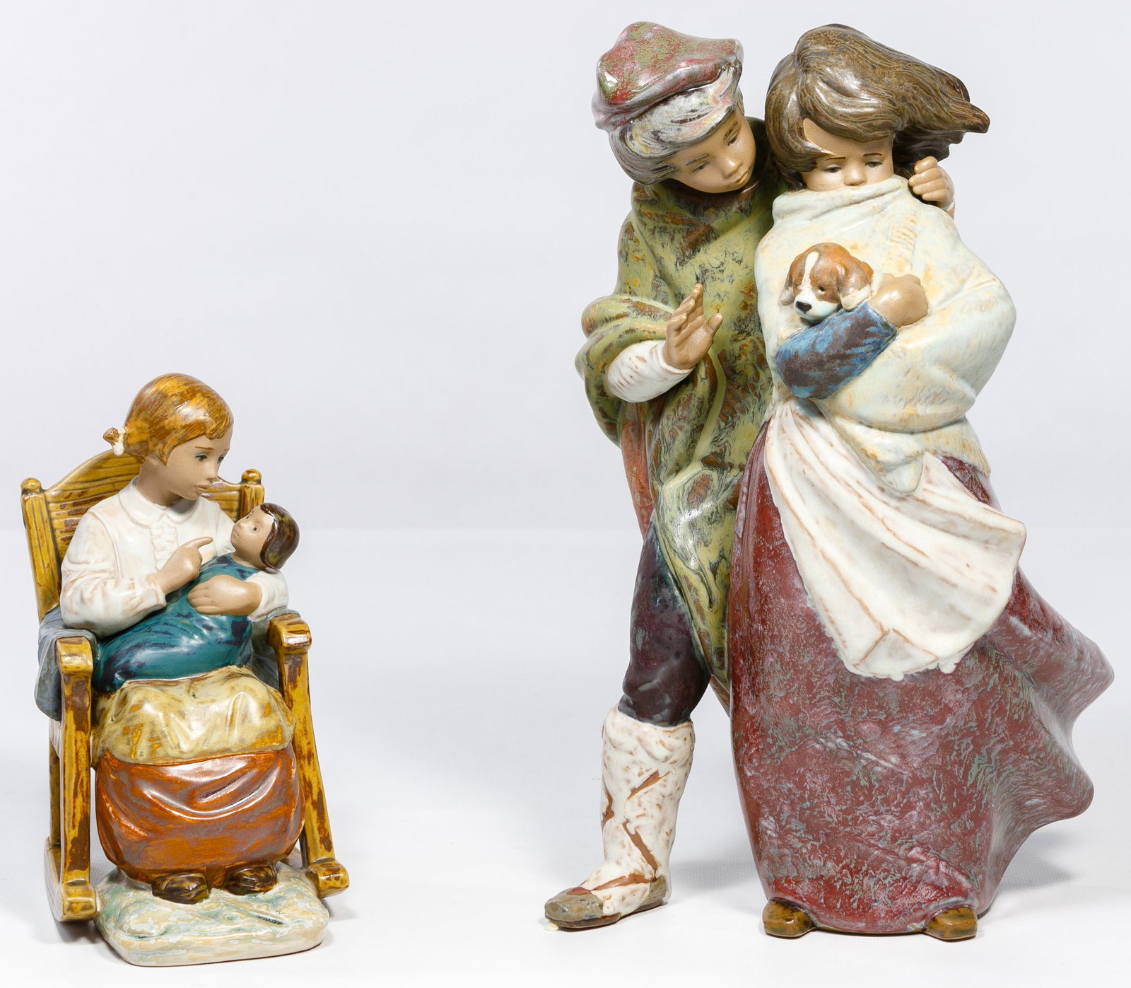 Lladro Figurines: Lladro Figurines Two gres finish items, #1279 'Facing the Wind' retired 2001 and #2089 'Girl in Rocking Chair' retired 1981 Condition: Very Good, no chips or cracks noted; overall light wear consisten