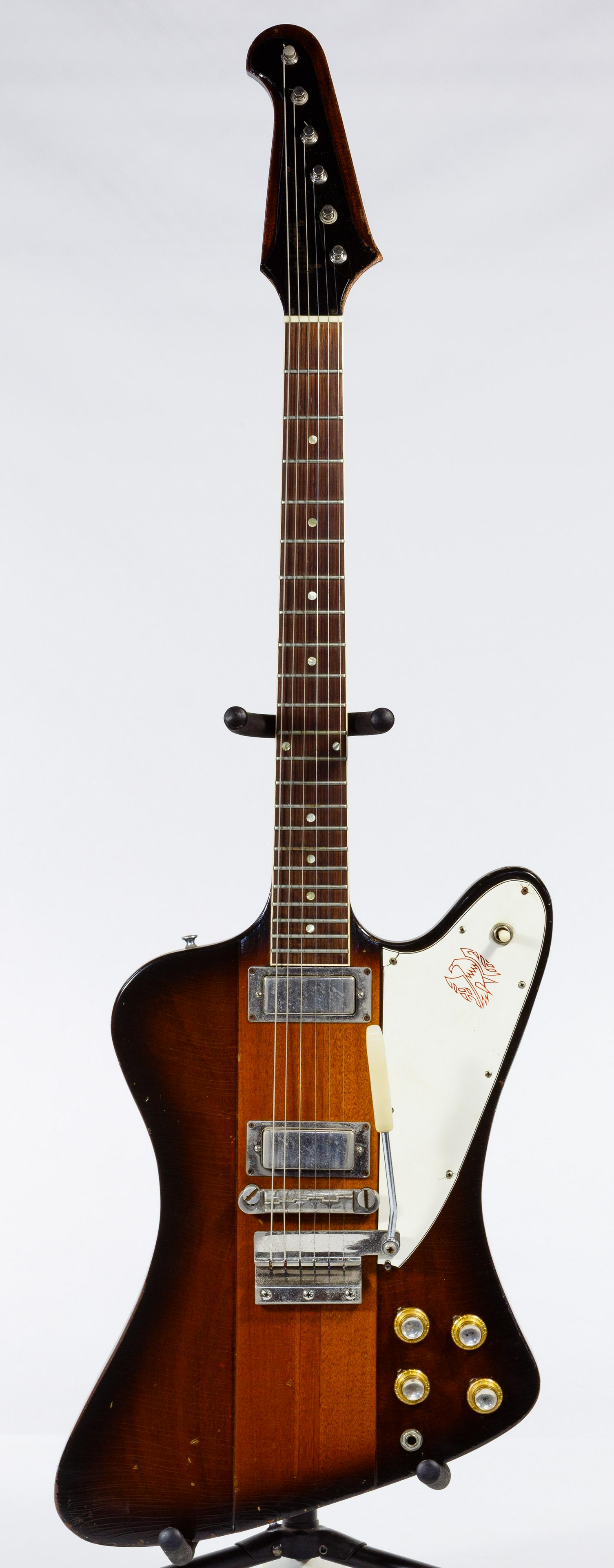 Gibson 1964 Firebird Electric Guitar: Gibson 1964 Firebird Electric Guitar Serial #179670, sunburst finish, six string having a rosewood fret board, firebird logo on the white pick guard, two volume dials, two tone dials, one toggle-switc