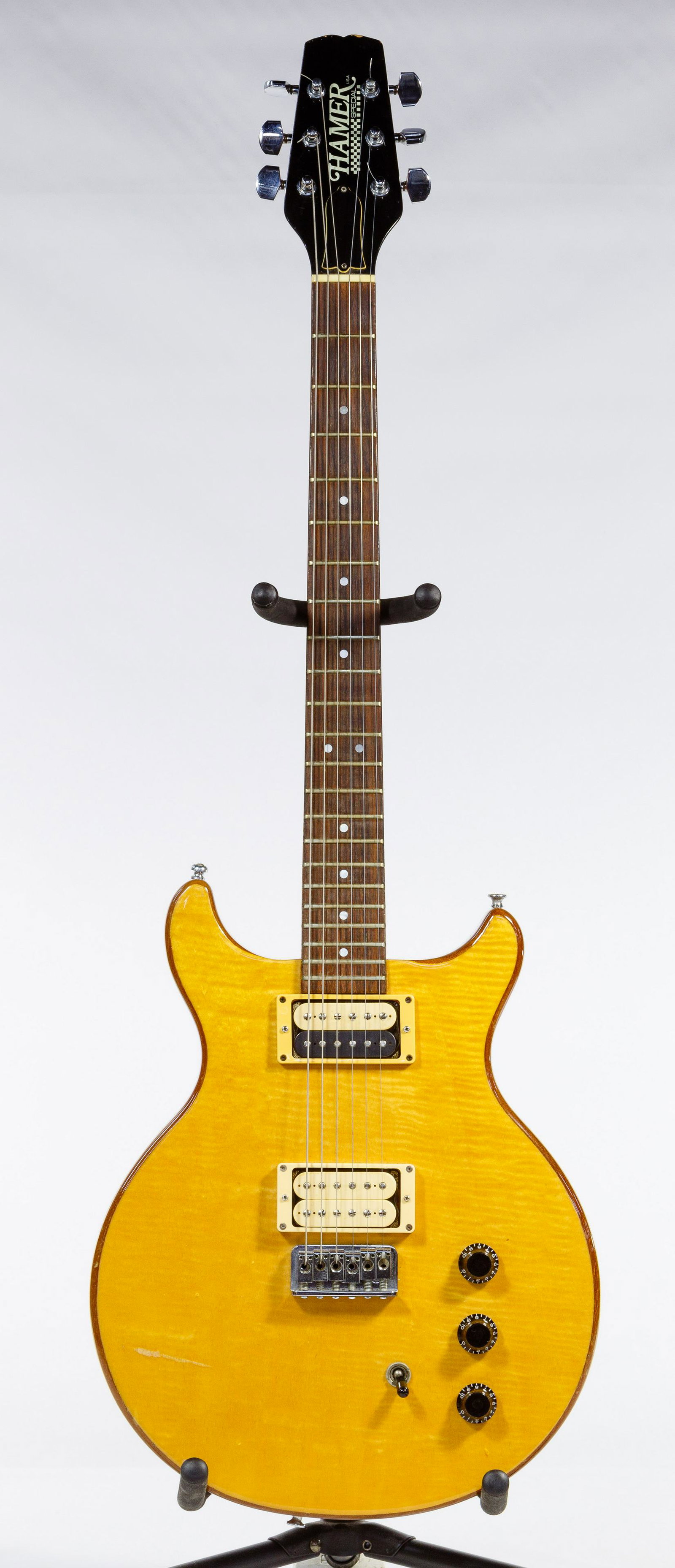 Hamer 1981 Special Guitar: Hamer 1981 Special Guitar Solid double-cutaway mahogany body, flame maple top in natural finish, string-through-body design with hard-tail bridge and six individual saddles, three skirted plastic cont