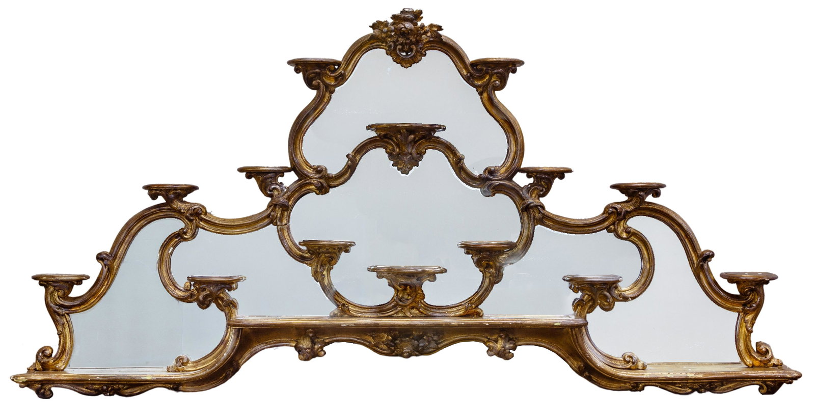 Italian Rococo Mirrored Wall Shelf: Italian Rococo Mirrored Wall Shelf 18th century, overall gold gilt having mirrored back and fourteen demilune shelves, the molded frame with flowers and rocaille ornamentation, provenance purchased at