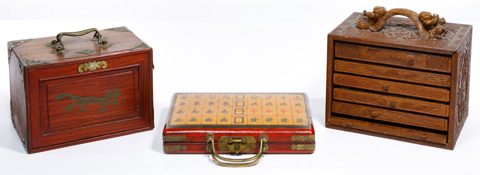 Mahjong Game Assortment: Mahjong Game Assortment Three sets including a complete set in a carved wood case having bone and ebonized wood playing pieces, a complete set with four trays, the pieces are made of scrimshawed bone 