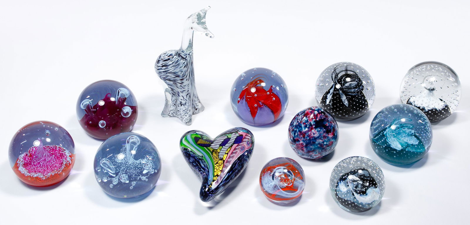 Caithness of Scotland Paperweight Assortment: Caithness of Scotland Paperweight Assortment Nine round glass having different colored swirls and bubbles inside, signed on underside; together with a Patterson heart signed on the underside, a multic
