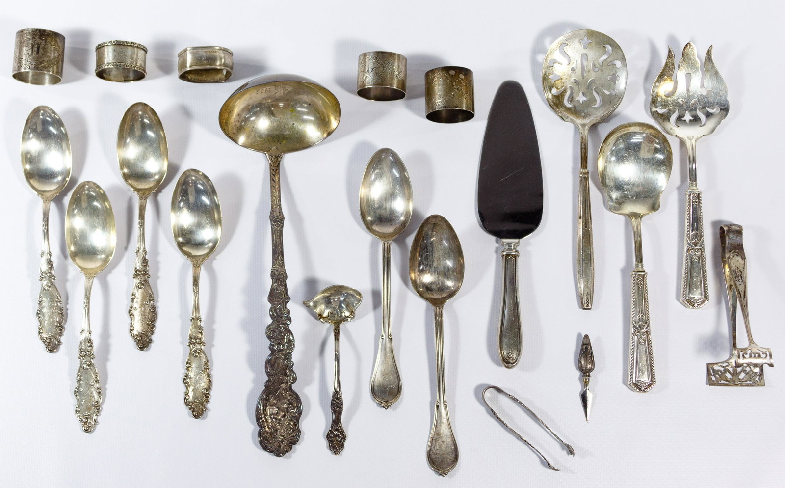 Sterling Silver Flatware Serving Assortment: Sterling Silver Flatware Serving Assortment Eighteen silver serving pieces including ladles, spoons, vegetable servers, cake knife, tongs and napkin holders; all marked 'sterling' or 'sterling handle'