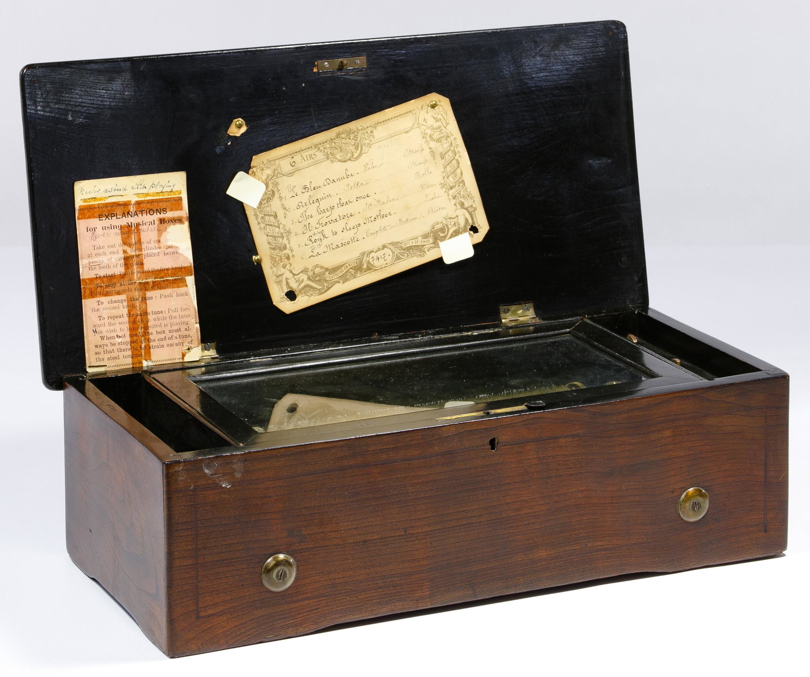 Swiss Marquetry Case Music Box: Swiss Marquetry Case Music Box Inlaid mahogany (6) air music box having an 8.25-inch brass cylinder, retaining a paper play list marked 'Etouffoirs en Acier Soit a Spiraux' and '#7417' with instructio