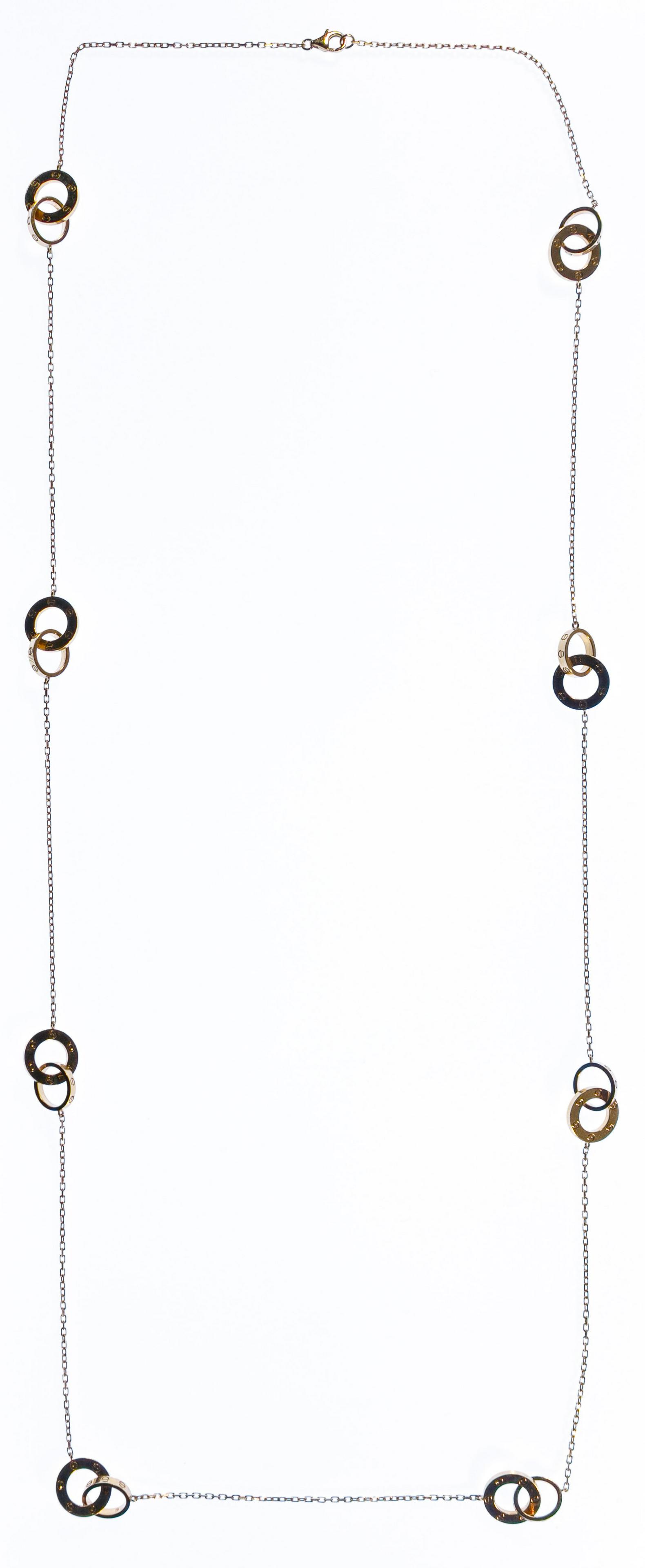 Cartier 18k Yellow Gold 'Love' Necklace: Cartier 18k Yellow Gold 'Love' Necklace Having interlocking rings connected by chain; marked 'Cartier', 'DQC698' and 'Au750'; from an Oak Park, Illinois collector Condition: Very Good, overall light w