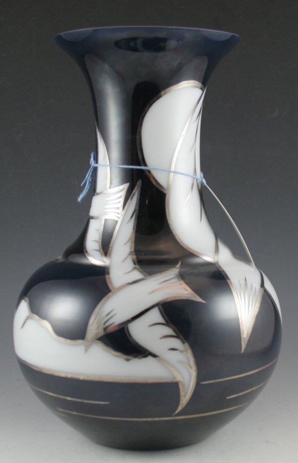 Karen Rogers silver overlay glass vase: Karen Rogers silver overlay glass vase. White body vase with applied black background and silver overlay of birds in flight. ca. 1970's DIMENSIONS: 13H x 6D top x 9D Widest x 4D base CONDITION: Good C