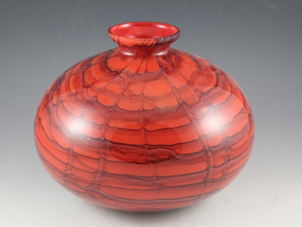 Czechoslovakia cased art glass vase: Czechoslovakia cased art glass vase. Red interior glass is shaded with circular random webbing design. ca. 1940's DIMENSIONS: 7 1/2H x 10D body x 3D neck CONDITION: Good Condition ESTIMATE: $100-$200 