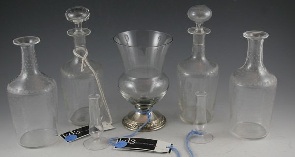 Set of Four Clear Etched glass Decanters: Set of Four Clear Etched glass Decanters, includes 2 stoppers. Pair of 3in Mini clear glass footed bud vases. Clear Glass 6in vase with silver pedestal base. DIMENSIONS: 7 1/2H CONDITION: Good Conditi