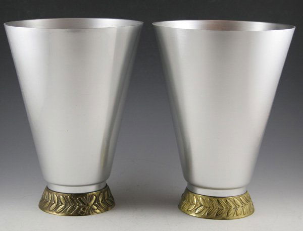 Pair of Kensington Marlborough Art Deco alumi: Pair of Kensington Marlborough Art Deco aluminum vases with laurel decorated brass base. Designed by Lurelle Guild with patent issued ca. 1935. ca. 1930's DIMENSIONS: 10H x 7 1/4D top CONDITION: Good