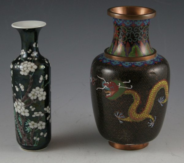 Chinese Famille Noire floral decorated vase: Chinese Famille Noire floral decorated vase. Double dragons design black cloisonne vase, as is. 3dents. DIMENSIONS: 5 3/4H & 6 1/2H CONDITION: Good Condition ESTIMATE: $60-$80 uest.