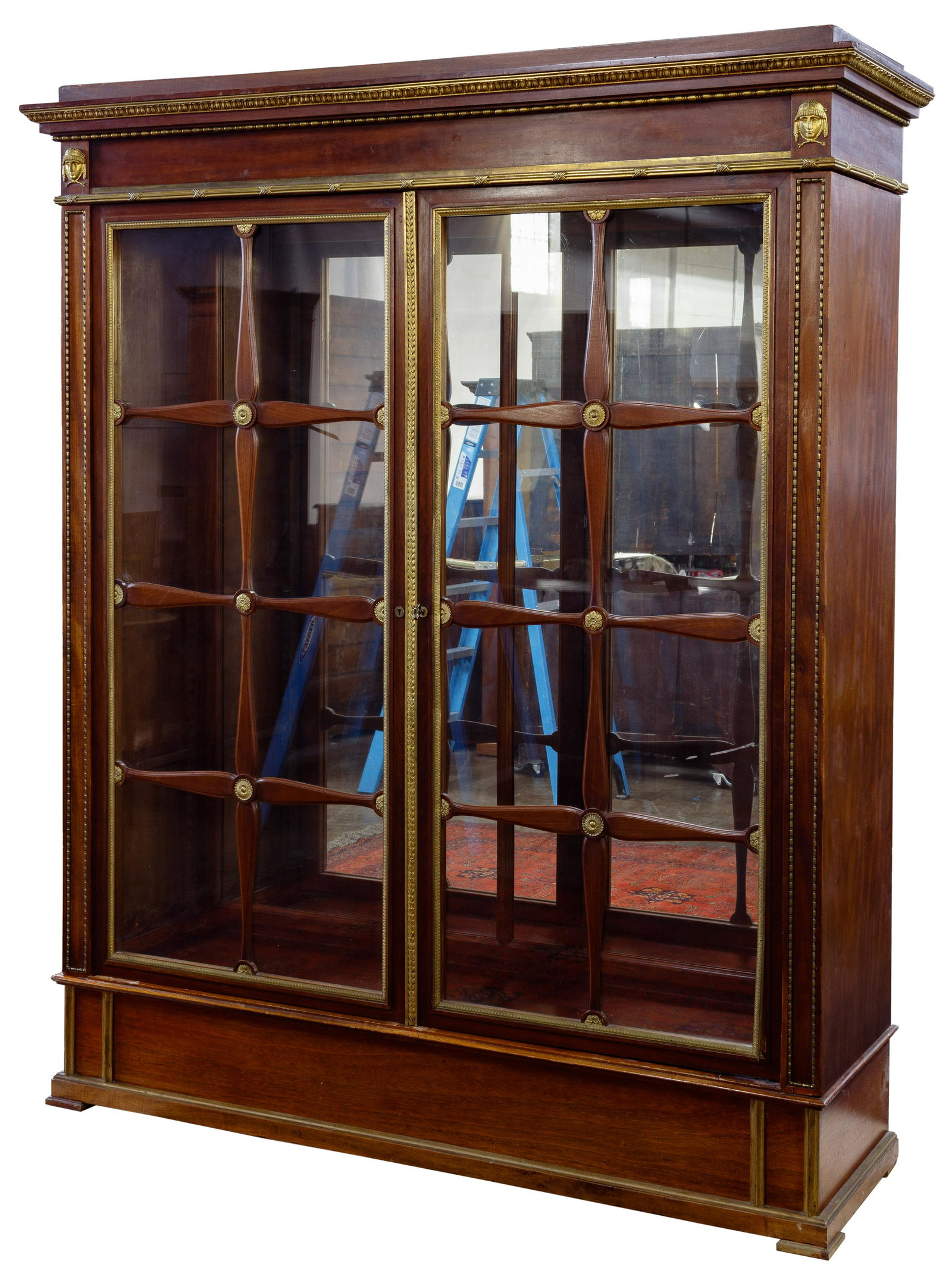 Wooden and Brass Display Cabinet: Wooden and Brass Display Cabinet Walnut and fruitwood veneer having brass accent molding, windowpane glass doors having brass medallions, brass molding and medallions on cornice; inside having lightin