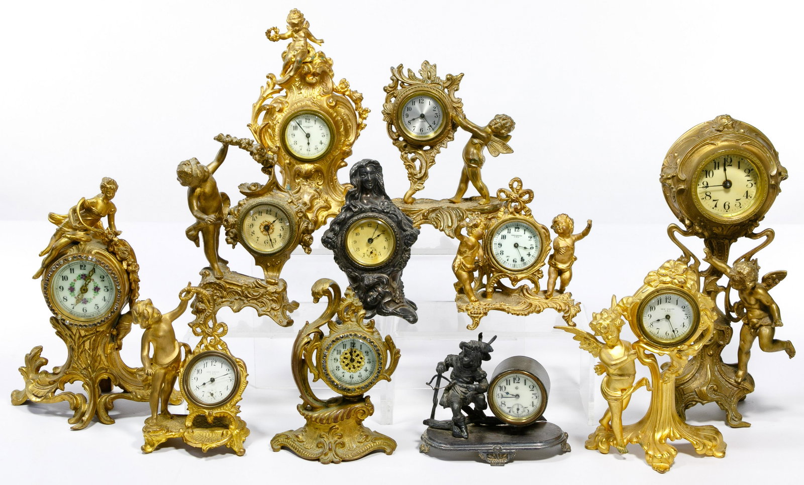 Cast Metal Mantel Clock Assortment: Cast Metal Mantel Clock Assortment (11) items including examples from (5) New Haven, a Wm. Gilbert, a Sessions; and (4) unmarked; all wind-up style, most with cherubs Property from: a Lake Forest, Ill