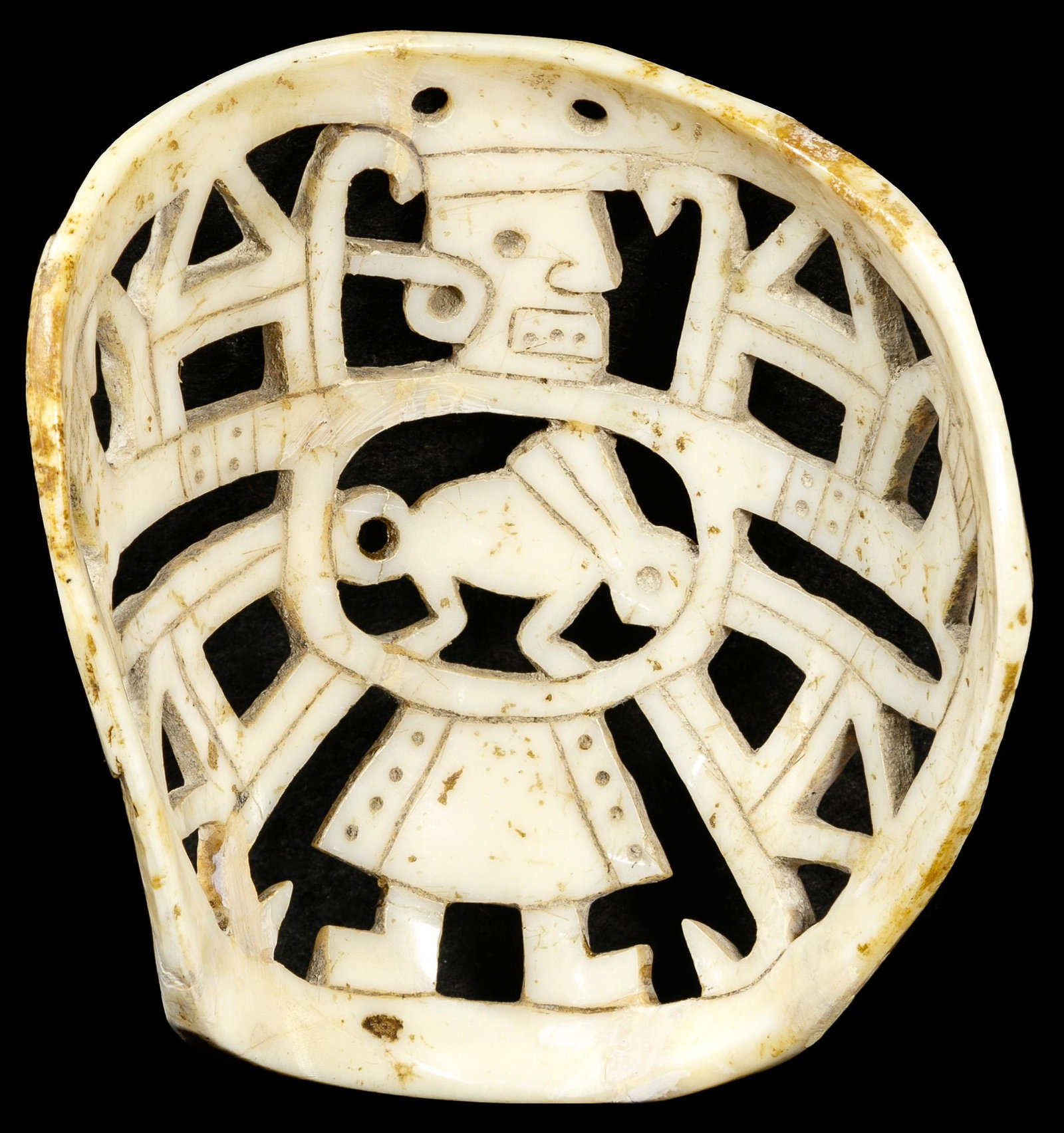 Mayan Style Carved Shell: Mayan Style Carved Shell Open work depicting a figure having outstretched arms, legs, a skirt and a rabbit in the center, geometric designs overall, two holes at the top for a necklace cord Property f