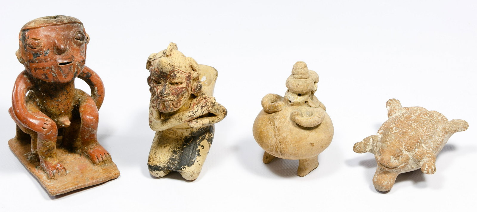 Pre-Columbian Style Figures: Pre-Columbian Style Figures (4) items including a Campeche Mayan style frog effigy pottery whistle, a West Mexican style rounded clay mother and child rattle, polychrome Nayarit style male sitting on 