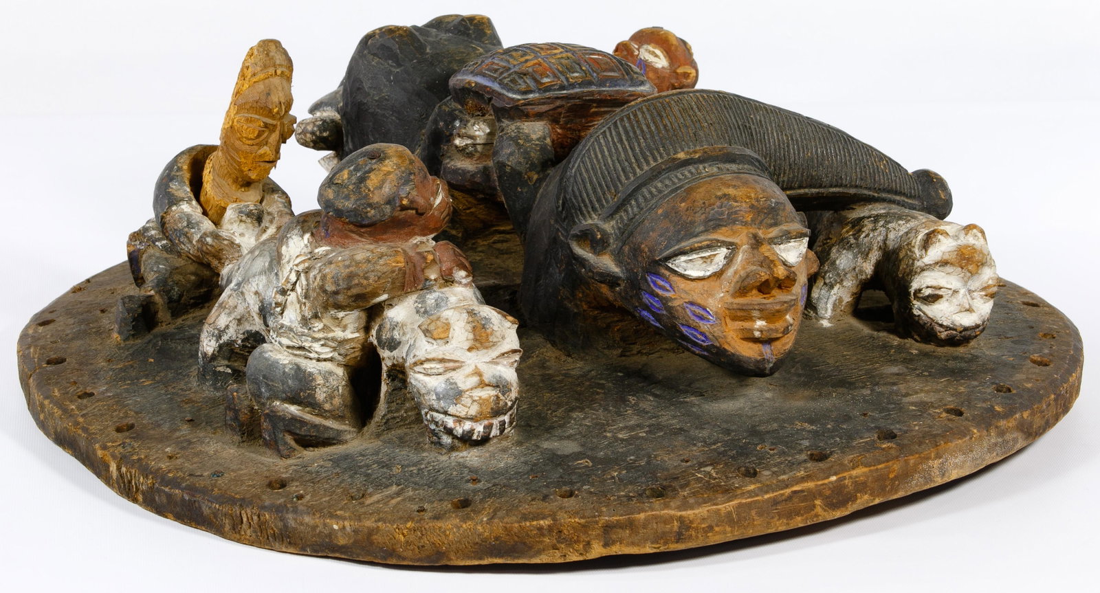 Yoruba Carved Divination Lid: Yoruba Carved Divination Lid Round wood cover having painted carvings of people, animals, dragon and a turtle Property from: a Dixon, Illinois estate Condition: Good, overall light wear consistent wit