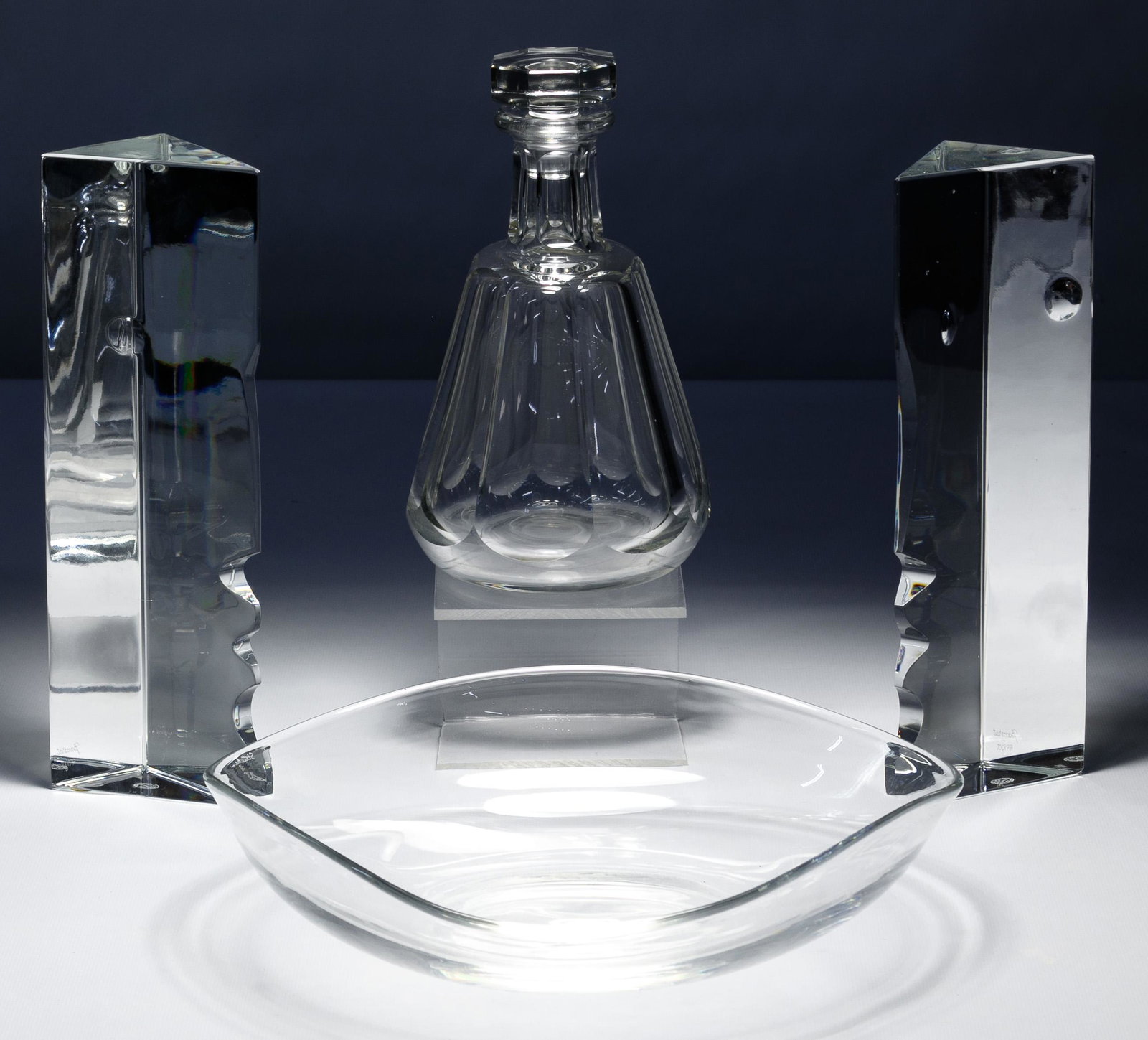 Richard Rigot for Baccarat Crystal 'Encounter' Figures: Richard Rigot for Baccarat Crystal 'Encounter' Figures Pair of stylized cubist face figures, artist signed en verso and stamped on underside; together with a Baccarat 'Tallyrand' decanter with stopper