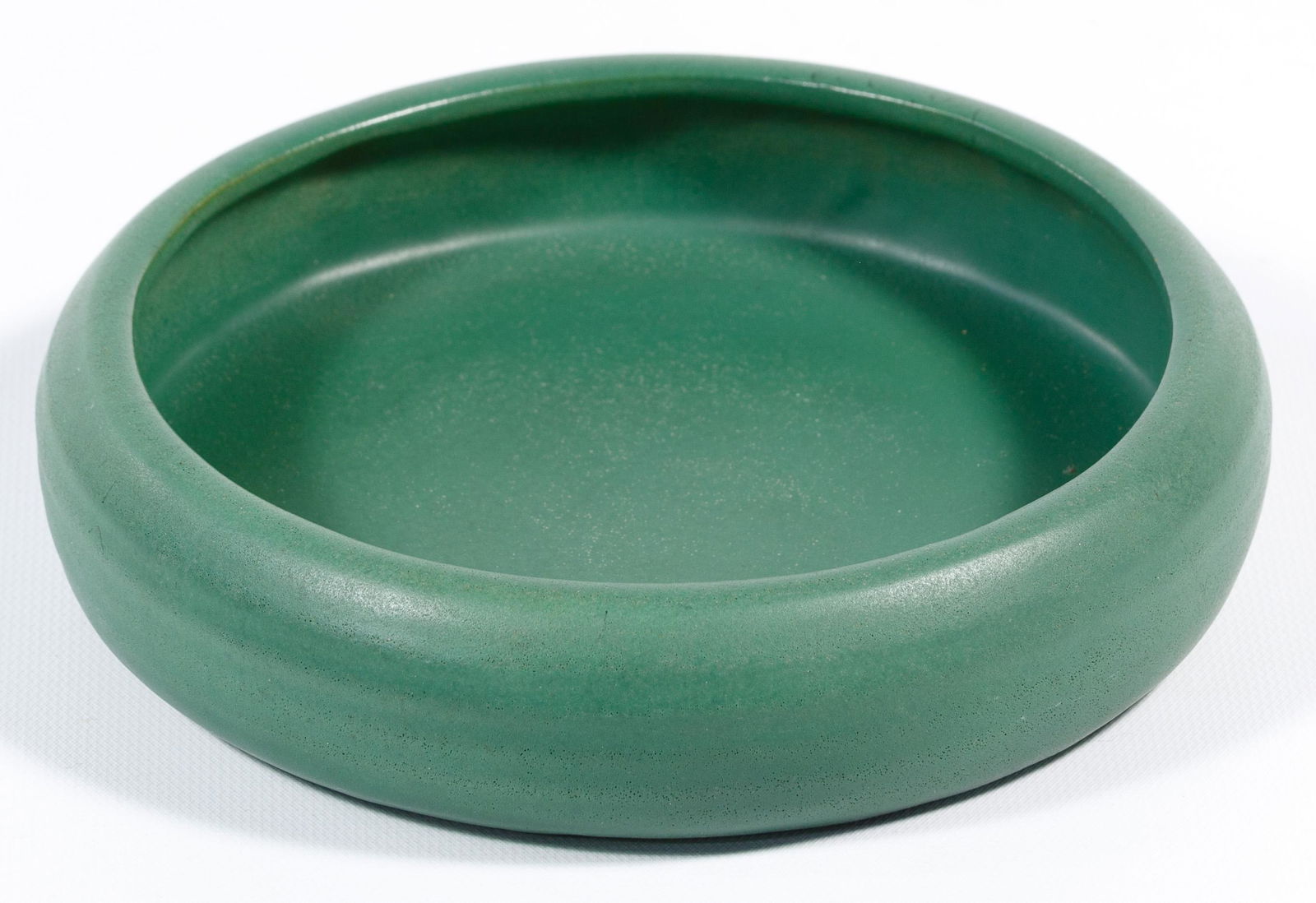 Teco Pottery Bowl: Teco Pottery Bowl Shallow green matte bowl; marked on bottom Condition: Very Good, light wear; no chips or cracks noted, possible repair inside bowl Height: 1 1/2 inches, Diameter: 7 inches Category: