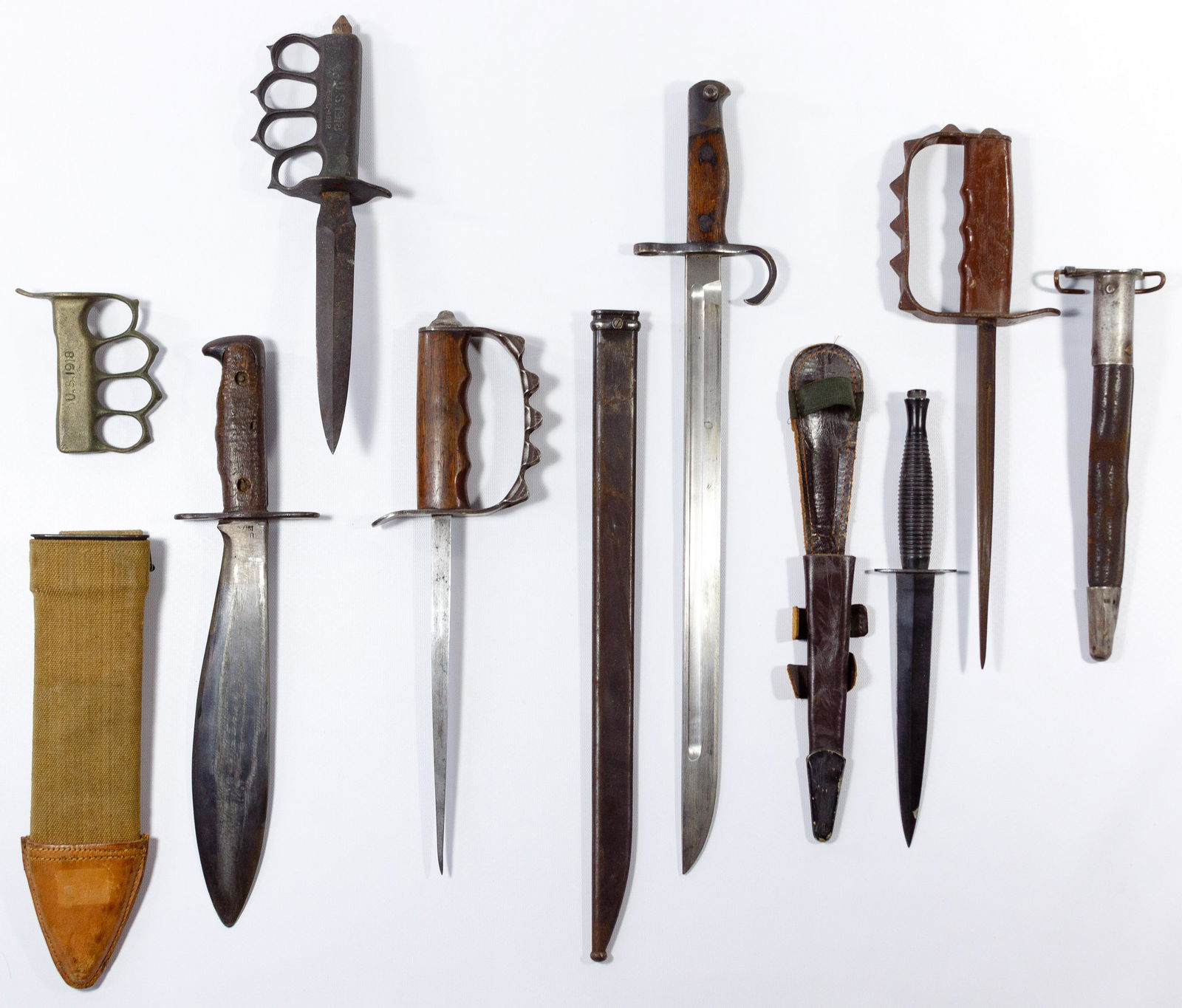 World War I and World War II Knife Assortment: World War I and World War II Knife Assortment (7) items including (4) World War I trench knives and knife grip; World War II British commando knife; World War II Japanese bayonet; and World War I bolo