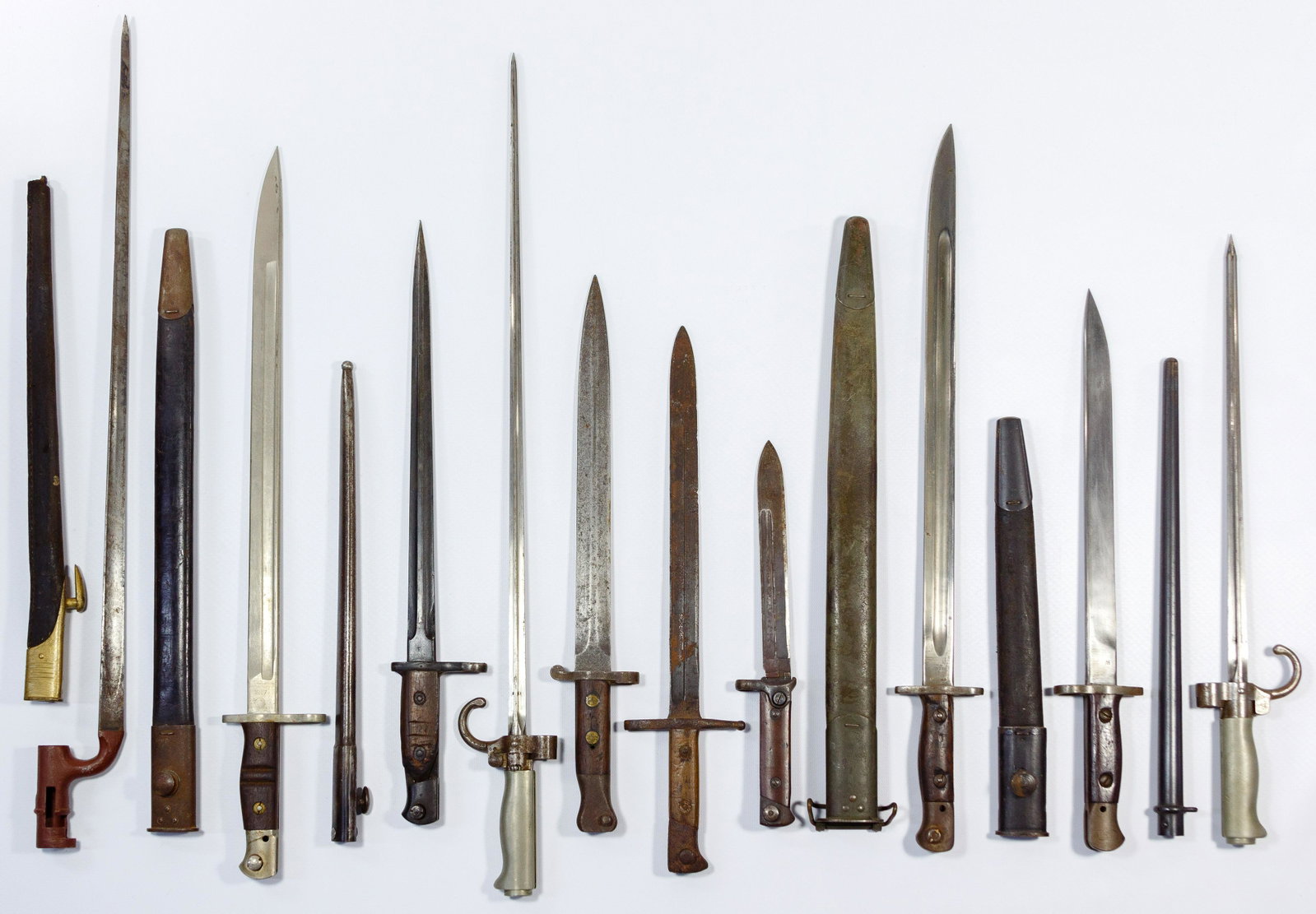 World War I British, French, Italian and American: World War I British, French, Italian and American Bayonet Assortment (10) items, featuring Remington 1917, Enfield 1907, MKII 1943, (6) having sheaths, several having markings on the ricasso, most hav