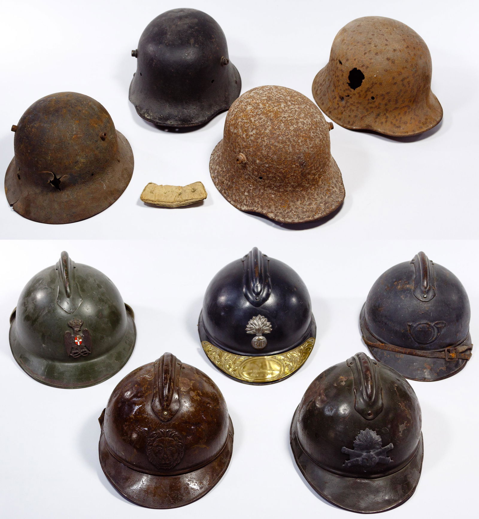 World War I Helmet Assortment: World War I Helmet Assortment (9) items including (5) French, Italian and Belgian Adrian helmets; (3) German helmet shells and a battle-damaged Bulgarian helmet shell Property from: the collection of