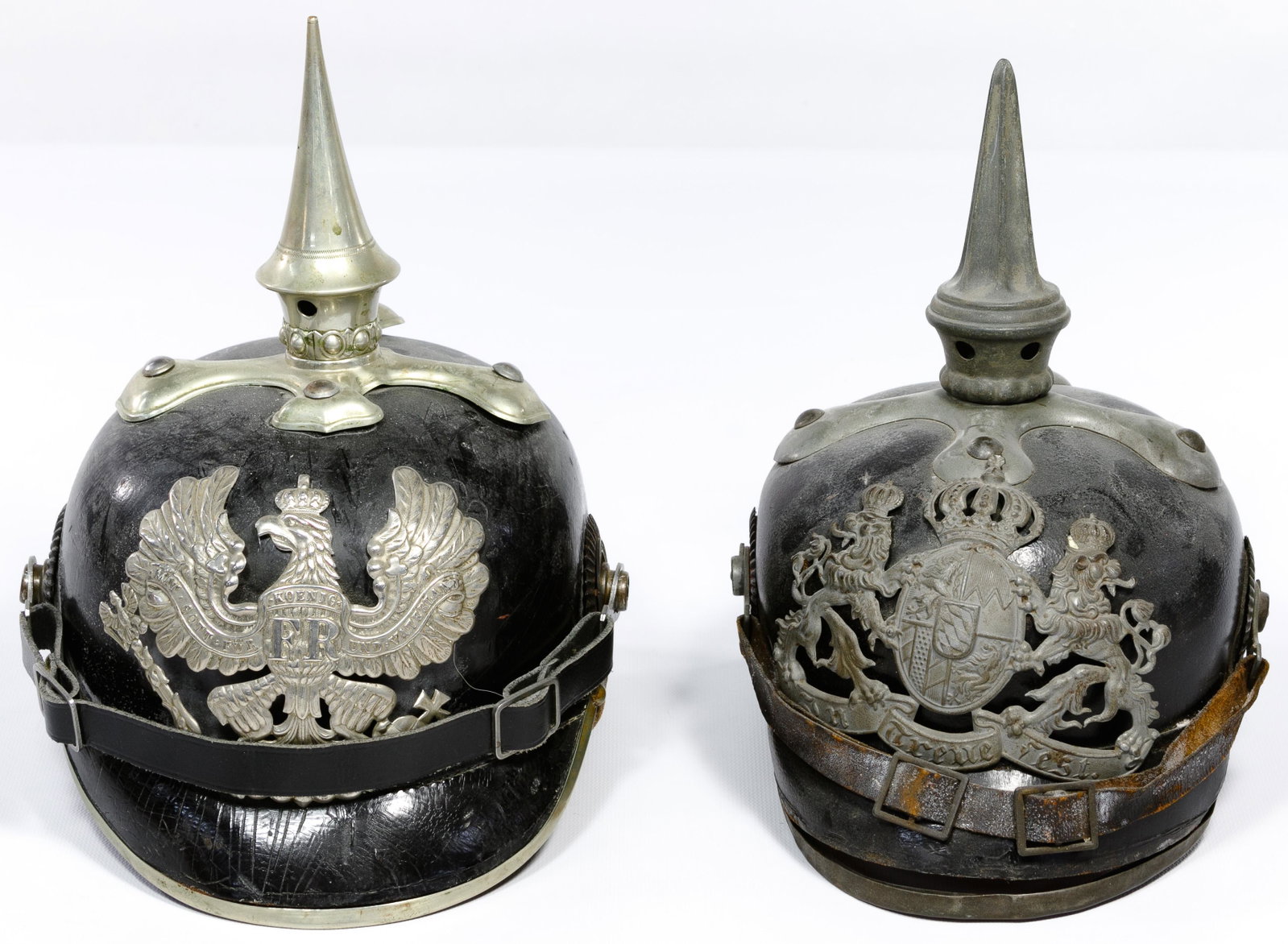 World War I Pickelhaube Helmets: World War I Pickelhaube Helmets (2) items including a Bavarian non-commissioned officers black leather body with gray metal accessories, leather chinstrap and taller spike; and Prussian NCO black leat