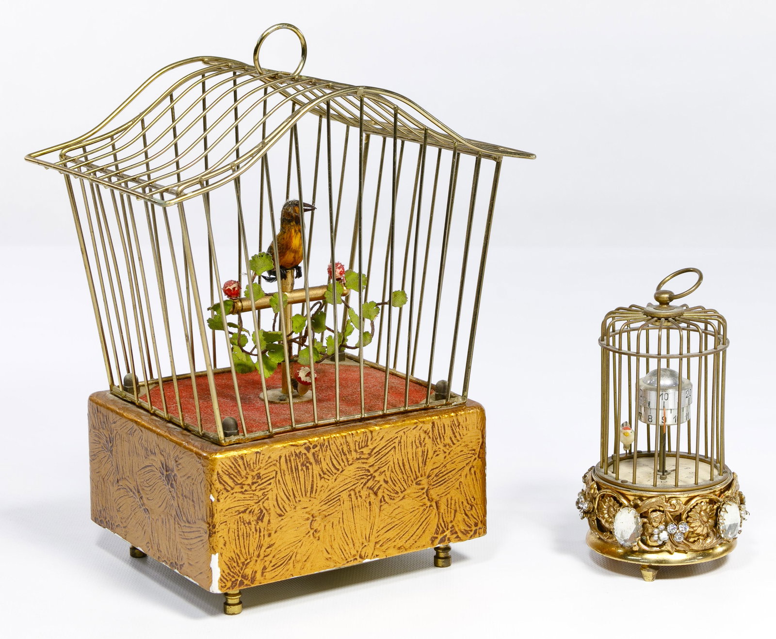 German Wind-Up Bird Cage Assortment: German Wind-Up Bird Cage Assortment (2) items including a bird cage alarm clock having a brass and jeweled cage marked 'J. Kaiser, Germany' on underside and a singing bird in metal cage having a gold 