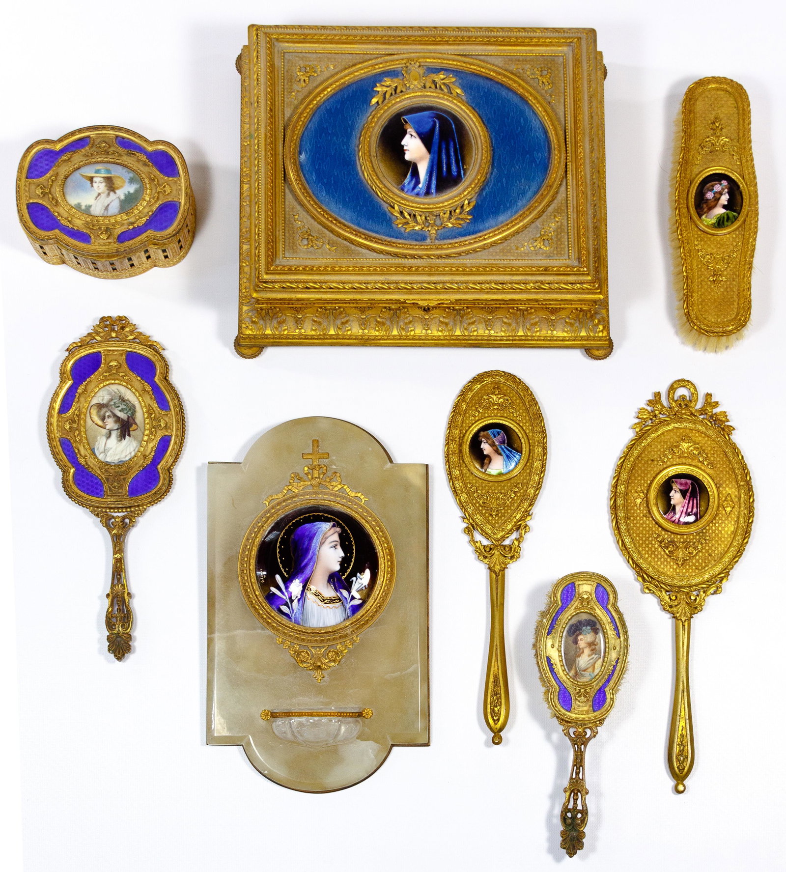 Gilt and Enamel Vanity Assortment: Gilt and Enamel Vanity Assortment (8) items including (3) hand mirrors, (2) brushes, a trinket box and a jewelry box, all having gold gilt metal bodies, enameled or painted insets depicting female por