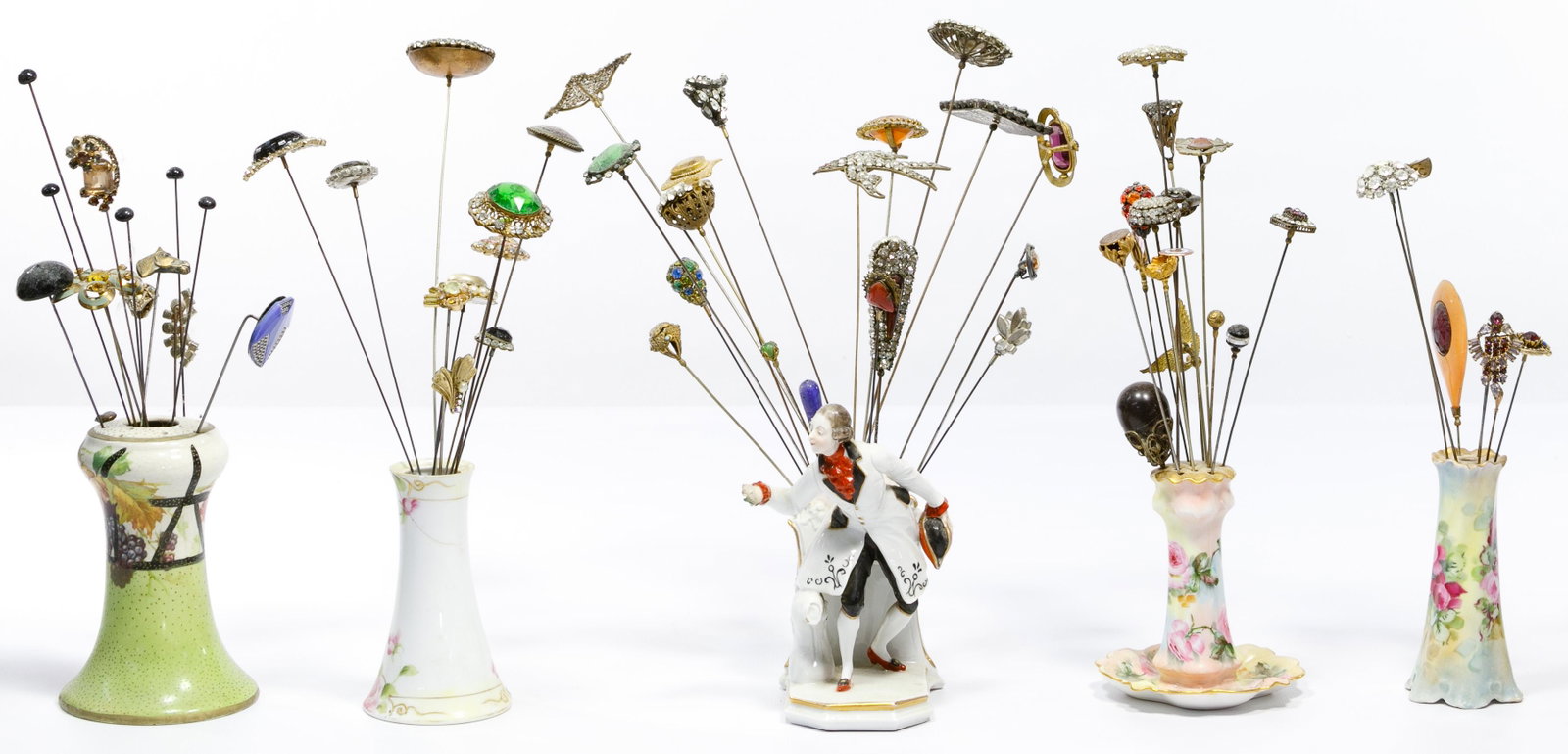 Hat Pin and Holder Assortment: Hat Pin and Holder Assortment Including approximately (64) hat pins of various lengths and ages, some having bakelite, pearls, cameos or rhinestones; together with hat pin holders Property from: a Lak