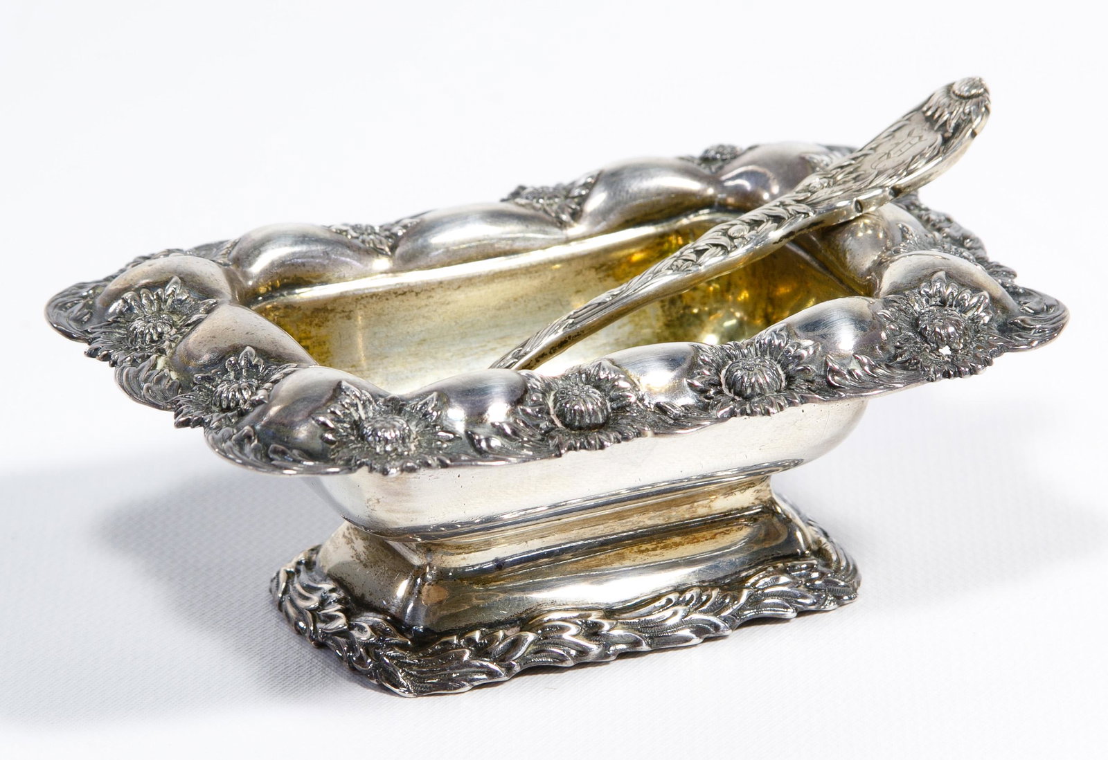 Tiffany & Co. Sterling Silver 'Chrysanthemum' Salt: Tiffany & Co. Sterling Silver 'Chrysanthemum' Salt Cellar and Spoon Having a repousse floral edge and handle; both stamped 'sterling', spoon monogrammed Property from: a Lake Forest, Illinois estate C