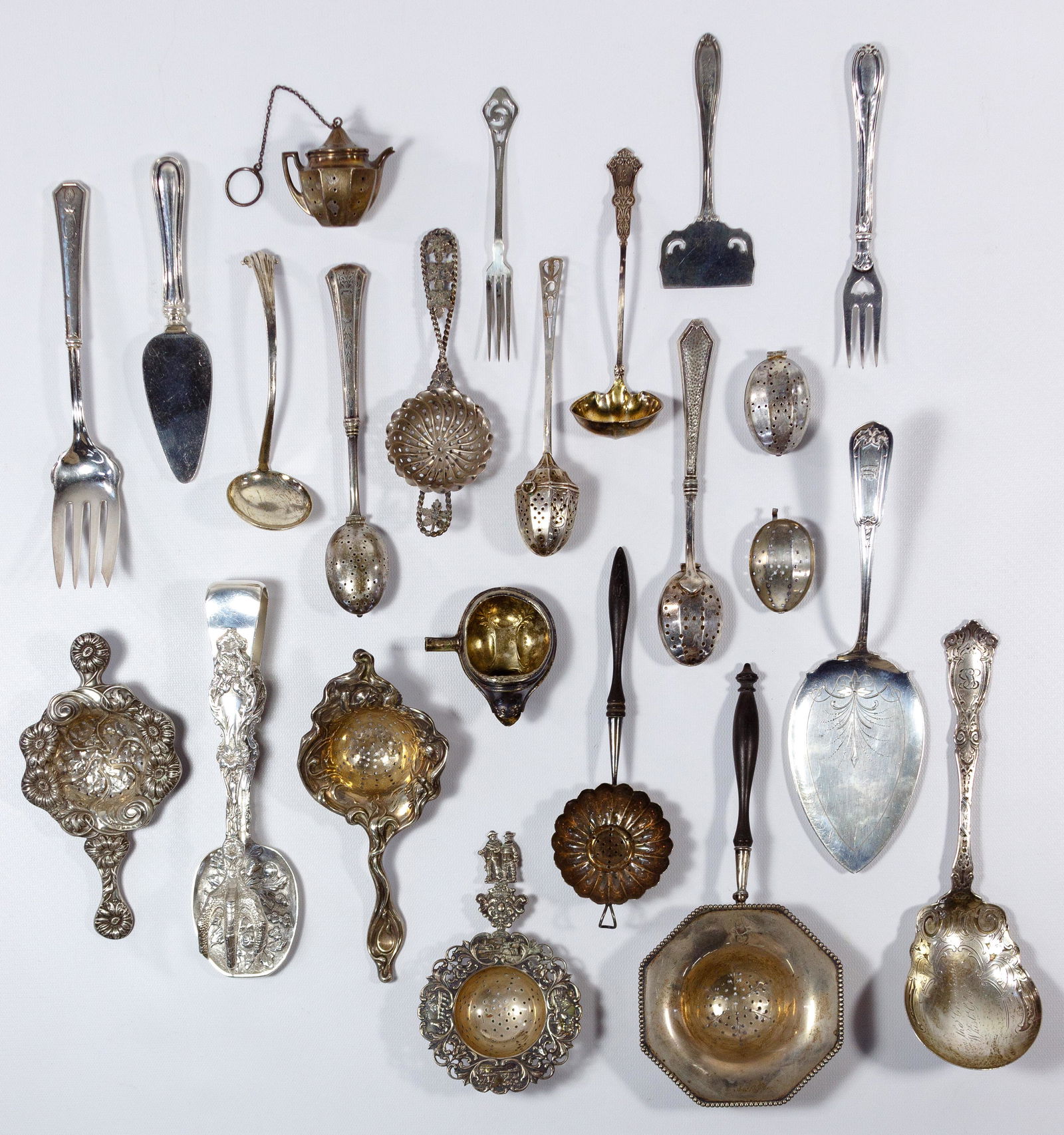 Sterling Silver Serving Utensil Assortment: Sterling Silver Serving Utensil Assortment (22) items including serving spoons, serving forks, tea strainers and serving tongs; all marked '925' or 'sterling' Property from: a Lake Forest, Illinois es